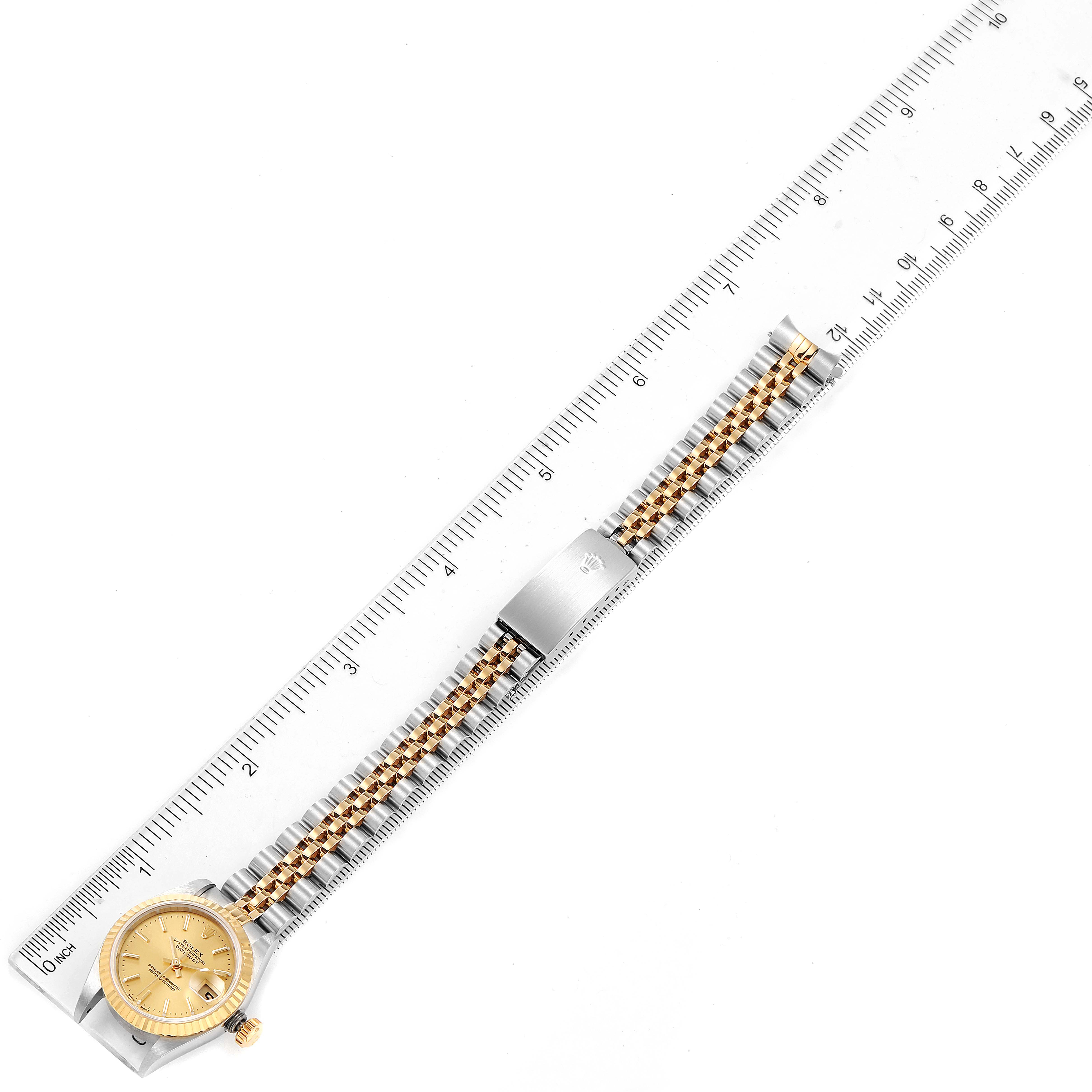 The image shows the full length of a Rolex Datejust 79173 Women's Steel and Gold (two tone) Champagne Dial 79173 Women's Steel and Gold (two tone) Champagne Dial watch, including the face, bezel, bracelet, and clasp, alongside a ruler for measurement.
