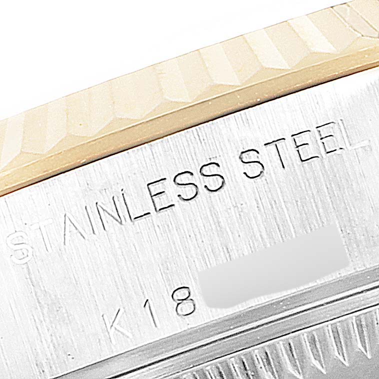 This close-up image shows part of the bezel and case of a Rolex Datejust 79173 Women's Steel and Gold (two tone) Champagne Dial 79173 Women's Steel and Gold (two tone) Champagne Dial watch, highlighting the stainless steel and K18 gold attributes.