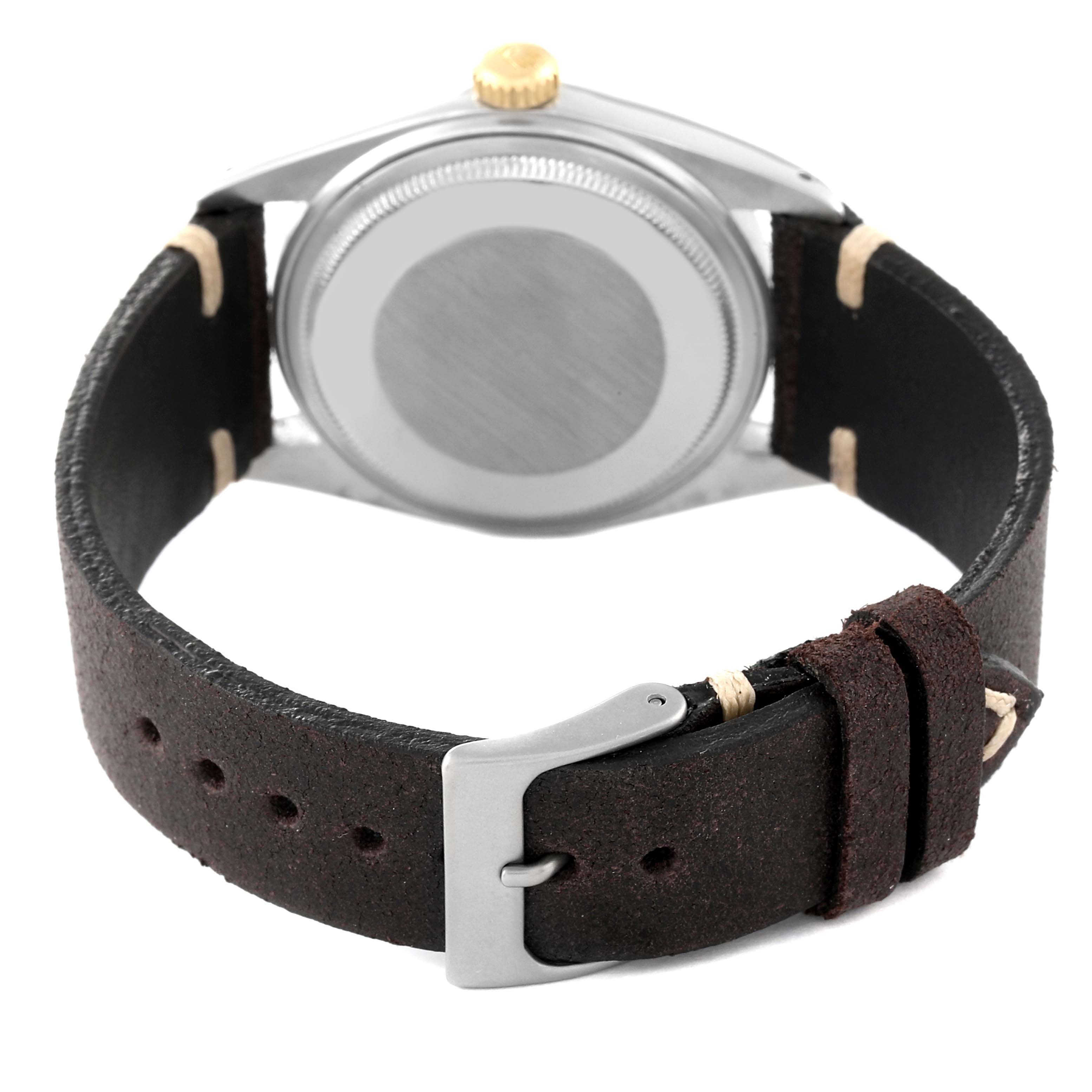 The image shows the back view of a Rolex Vintage Collection 16013 Men's Steel and Gold (two tone) Champagne Dial 16013 Men's Steel and Gold (two tone) Champagne Dial watch, featuring its case back, crown, and leather strap with a buckle.