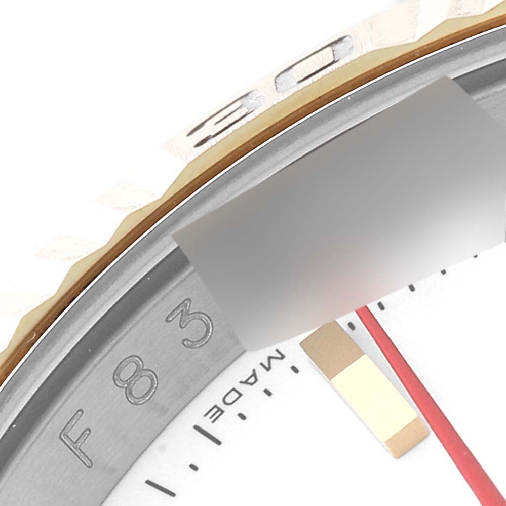 This close-up image of the Rolex Turn-o-Graph 116263 Men
s Steel and Gold (two tone) White Dial 116263 Men
s Steel and Gold (two tone) White Dial model shows a portion of the bezel and part of the dial with hour markers.