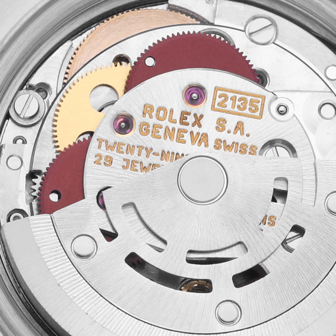The image shows the intricate movement mechanism of a Rolex Datejust 69173 Women's Steel and Gold (two tone) Blue Dial 69173 Women's Steel and Gold (two tone) Blue Dial watch, highlighting gears and the rotor.