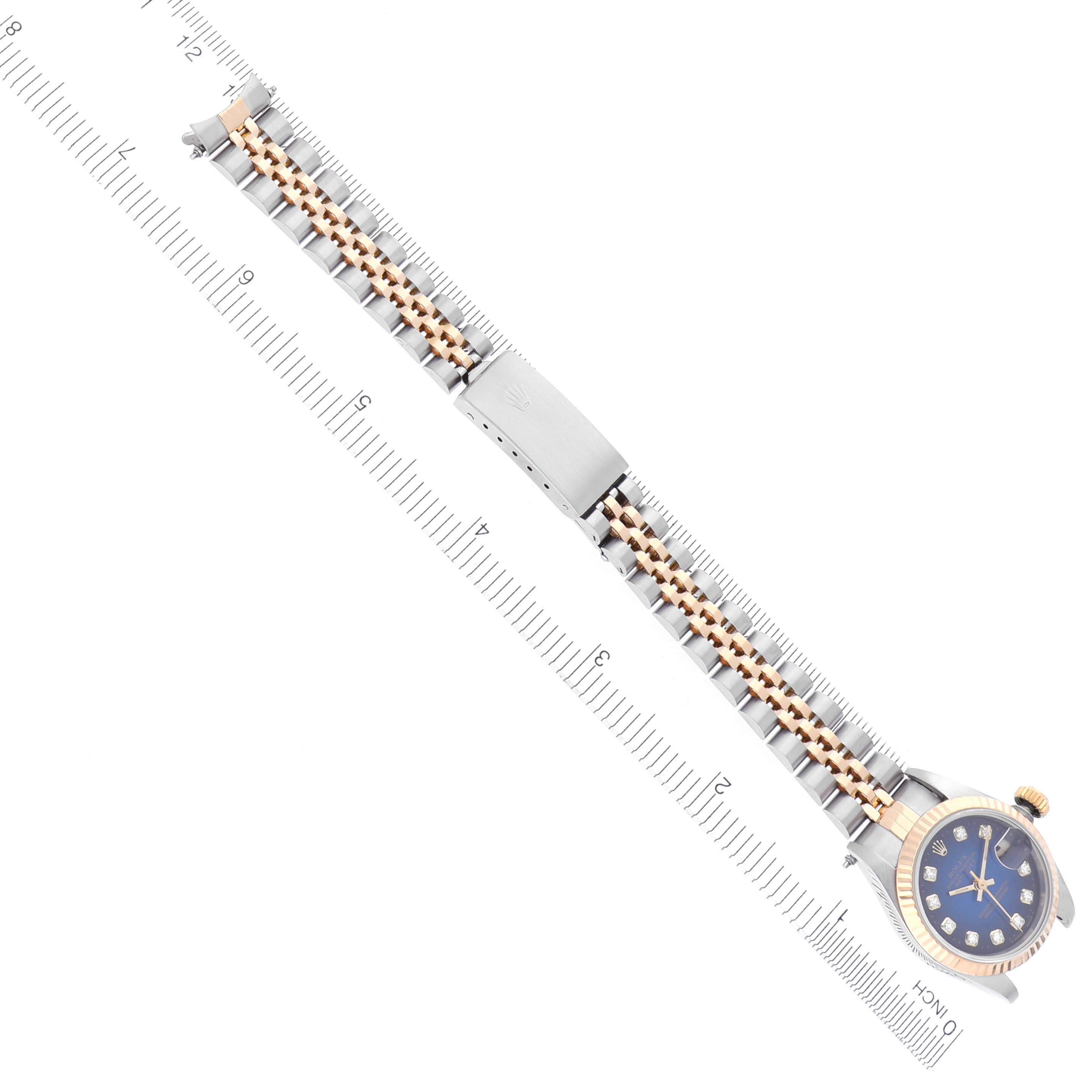 The Rolex Datejust 69173 Women's Steel and Gold (two tone) Blue Dial 69173 Women's Steel and Gold (two tone) Blue Dial watch is shown at an angle displaying the bracelet and face alongside a measuring ruler.