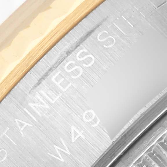 The image shows a close-up of the edge and part of the bezel of a Rolex Datejust 69173 Women's Steel and Gold (two tone) Blue Dial 69173 Women's Steel and Gold (two tone) Blue Dial, highlighting "STAINLESS" on the case.