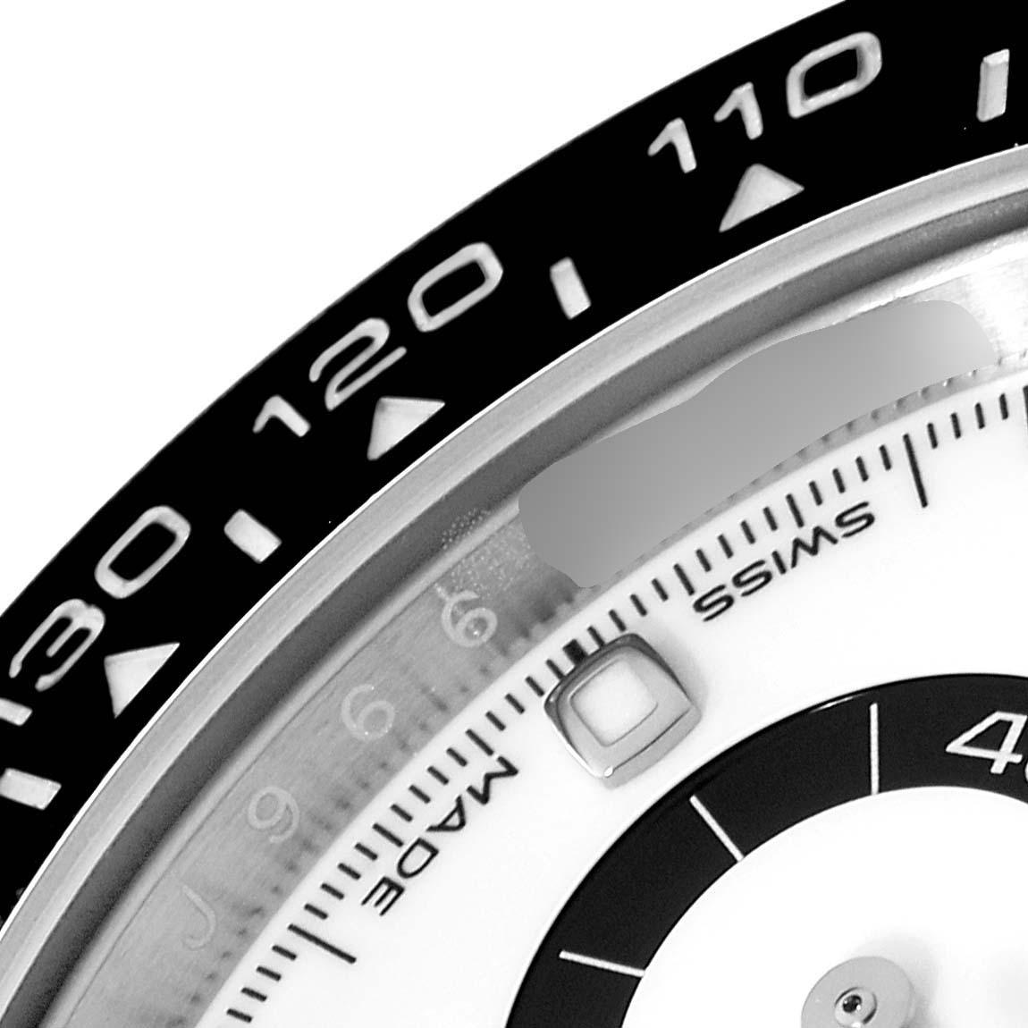 This close-up image of the Rolex Daytona 116500 Men's Stainless Steel White Dial 116500 Men's Stainless Steel White Dial shows the bezel, part of the dial, and the sub-dials.