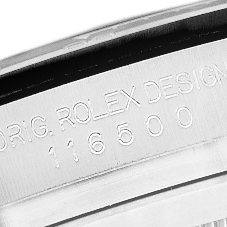 The image shows a close-up of the engraved text on the inner bezel of a Rolex Daytona 116500 Men's Stainless Steel White Dial 116500 Men's Stainless Steel White Dial watch.