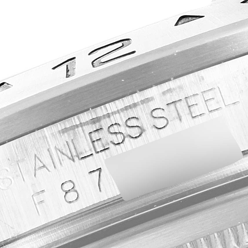 This close-up image shows the stainless steel bezel and part of the engraved text on the backside of a Rolex Explorer 16570 Men
s Stainless Steel White Dial 16570 Men
s Stainless Steel White Dial watch.