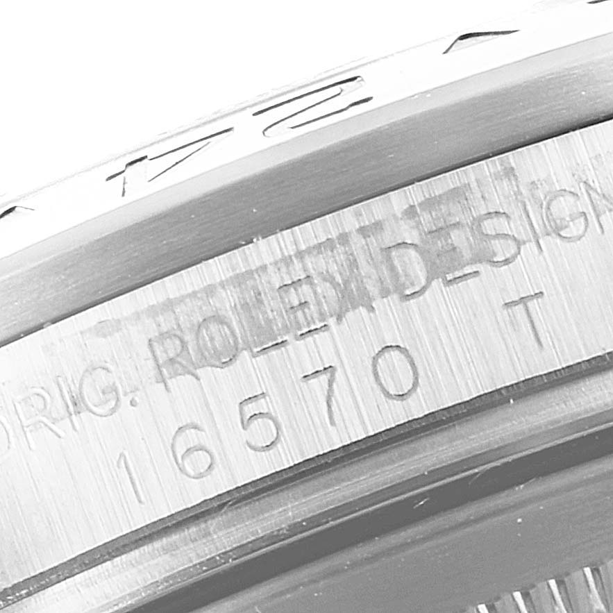 The image shows an angled close-up of the case side of a Rolex Explorer 16570 Men
s Stainless Steel White Dial 16570 Men
s Stainless Steel White Dial, highlighting the engraved model number "16570."