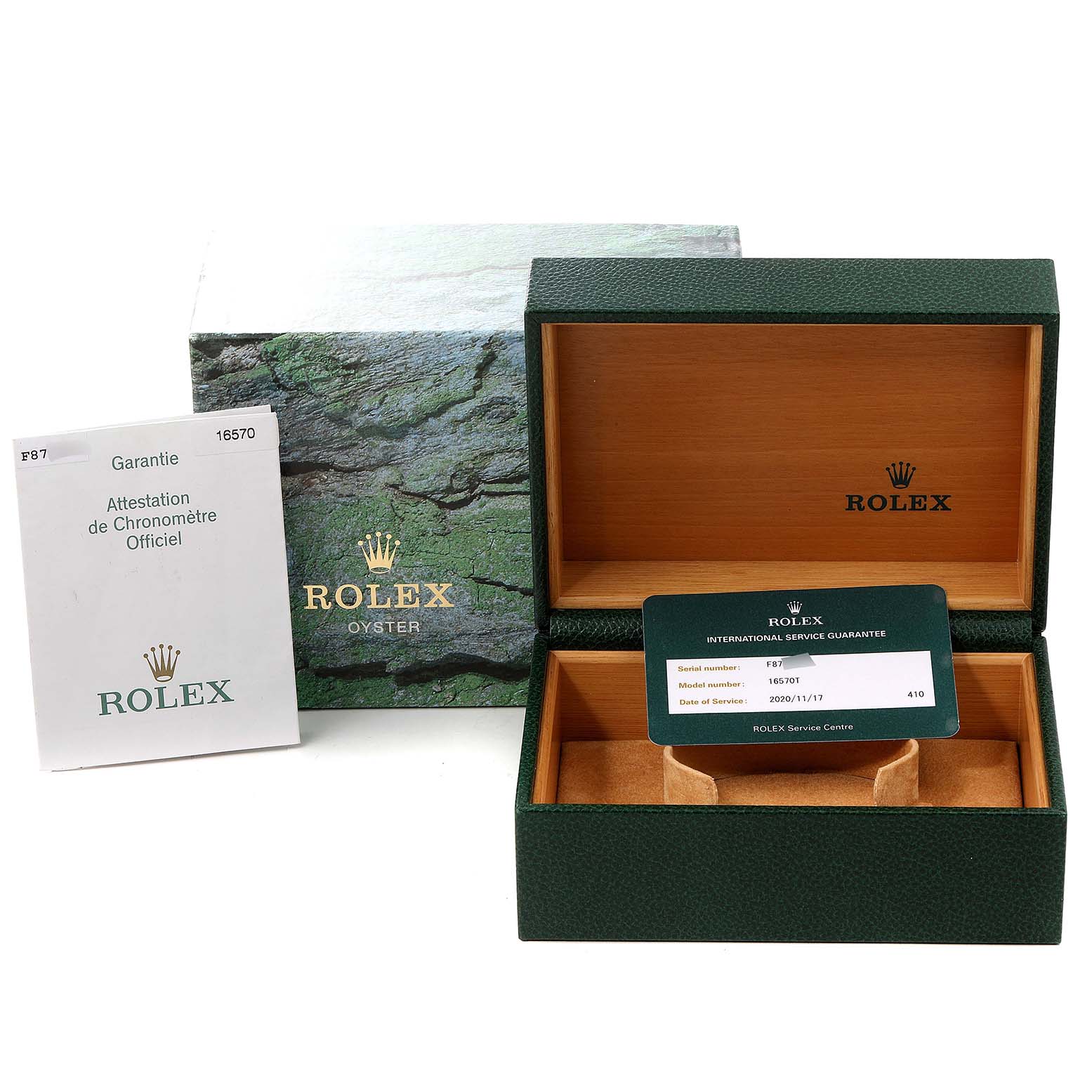 The image shows the packaging for a Rolex Explorer 16570 Men
s Stainless Steel White Dial 16570 Men
s Stainless Steel White Dial model including the box, warranty card, and certification booklet.