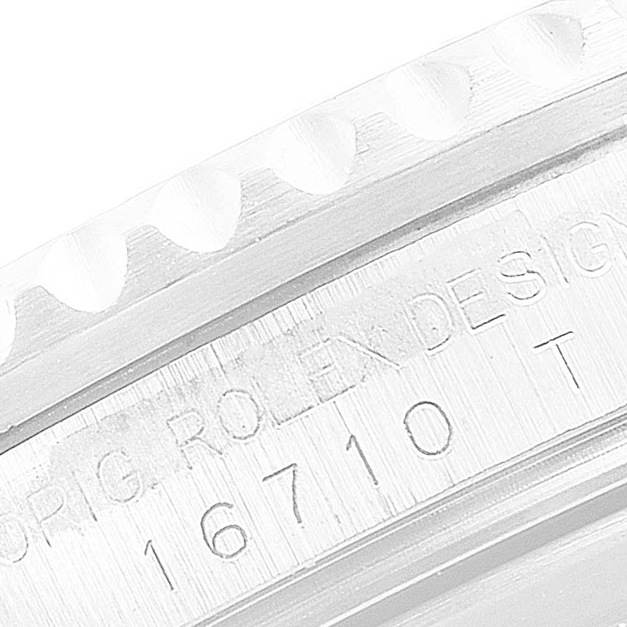 This close-up angle shows the etched model number and part of the bezel of a Rolex GMT-Master 16710 Men
s Stainless Steel Black Dial 16710 Men
s Stainless Steel Black Dial watch.