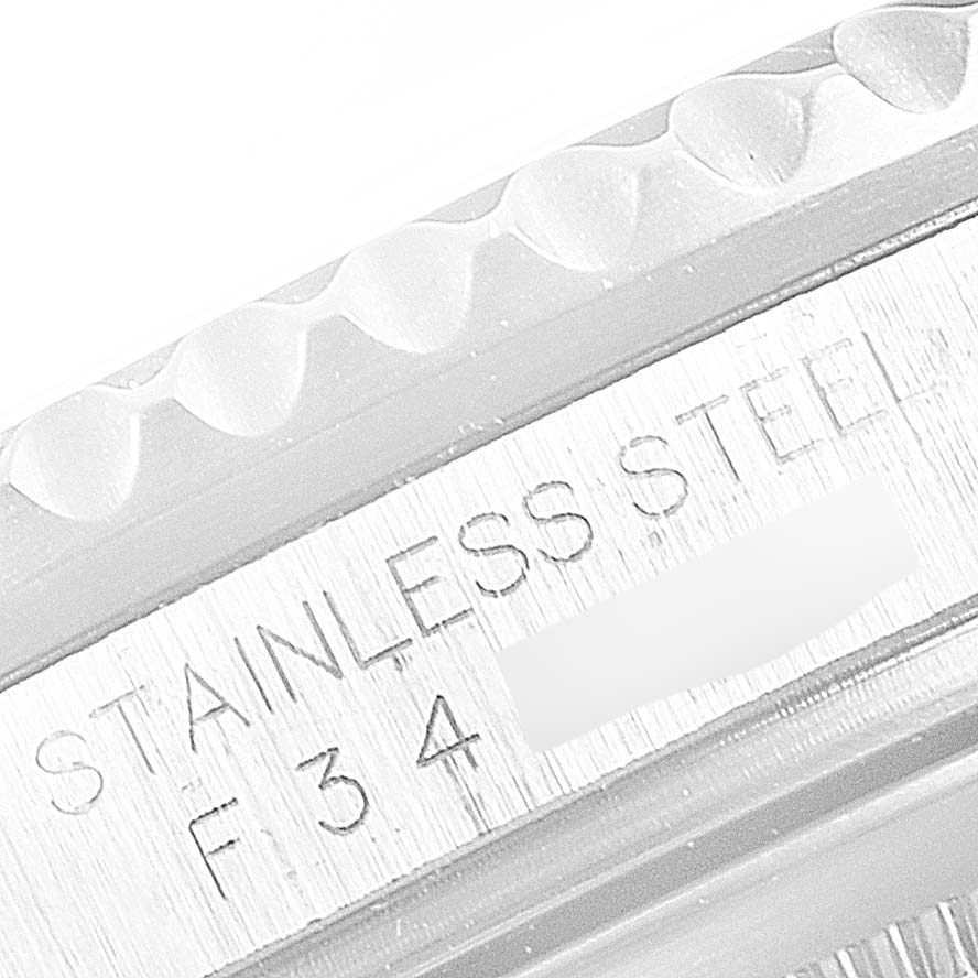 This close-up image shows the engraving on the side of the case of a Rolex GMT-Master 16710 Men
s Stainless Steel Black Dial 16710 Men
s Stainless Steel Black Dial watch, indicating stainless steel.