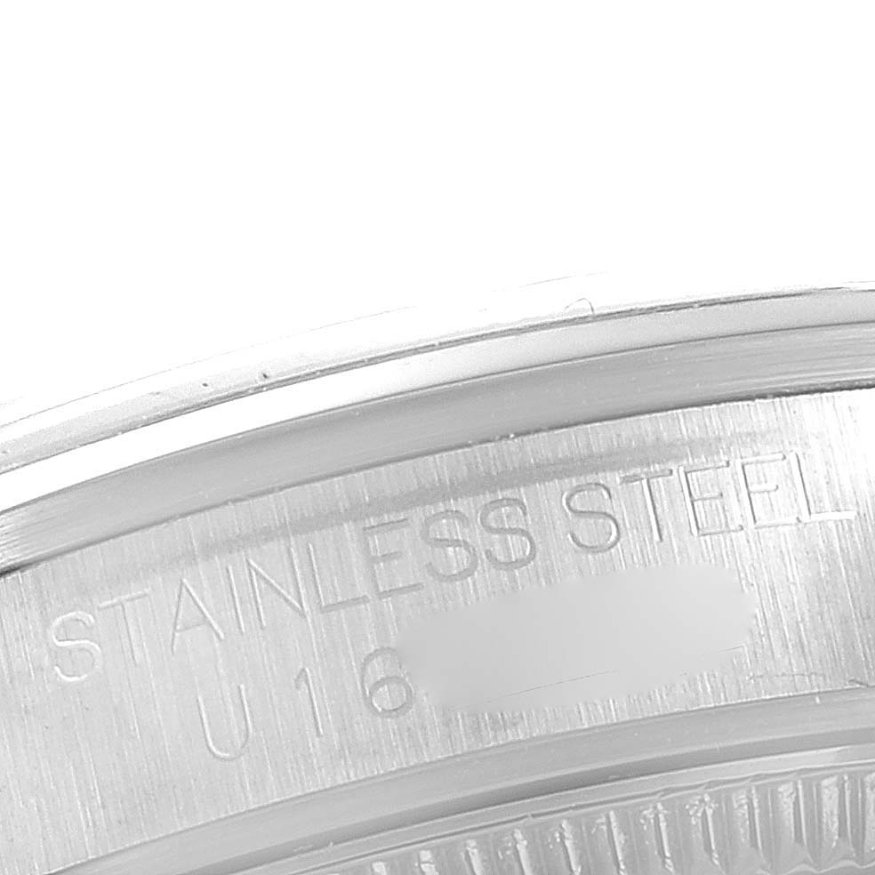 This image shows a close-up of the case back of a Rolex Mid-Size 67480 Women's Stainless Steel Black Dial 67480 Women's Stainless Steel Black Dial model, highlighting the "STAINLESS STEEL" marking.