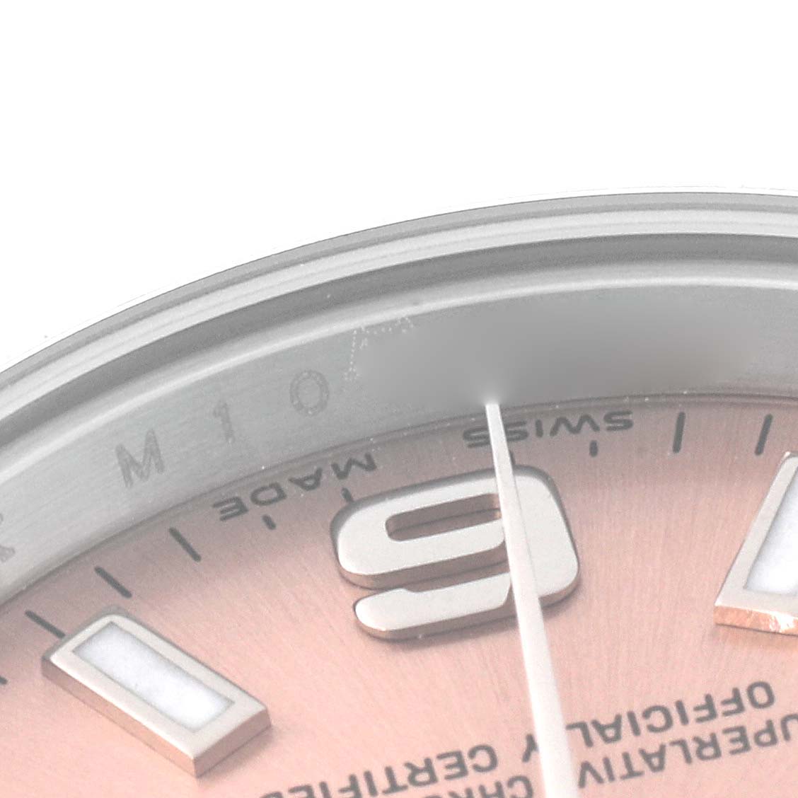 The image shows a close-up angle of the dial
s edge, numeral marker, and part of the minute hand of a Rolex Oyster Perpetual 176200 Women
s Stainless Steel Pink Dial 176200 Women
s Stainless Steel Pink Dial watch.