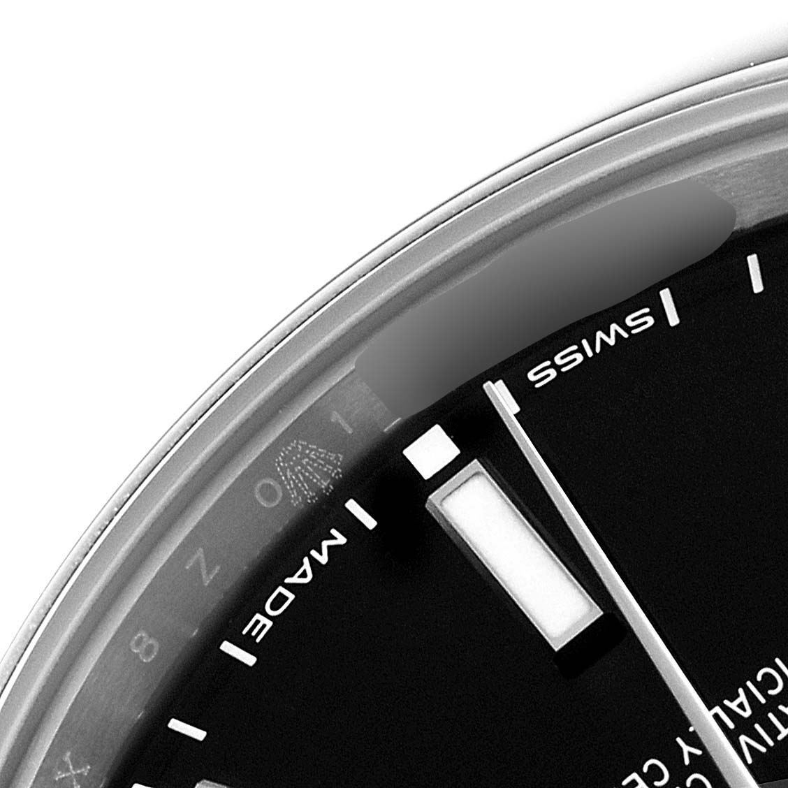 The image shows a close-up of the dial, hands, and edge of the bezel of a Rolex Oyster Perpetual 114300 Men
s Stainless Steel Black Dial 114300 Men
s Stainless Steel Black Dial watch.