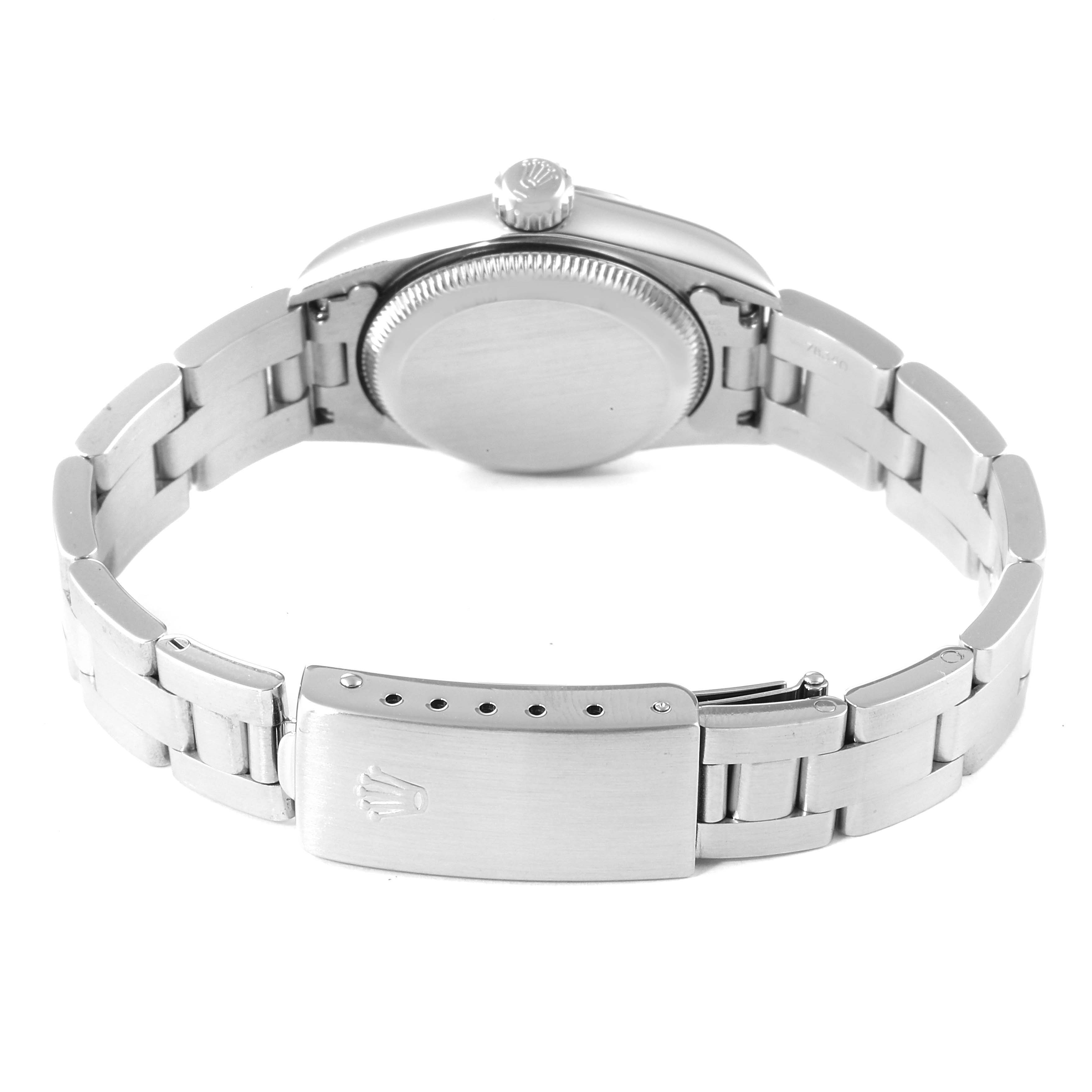 The image shows the back view of a Rolex Oyster Perpetual 67230 Women's Stainless Steel Blue Dial 67230 Women's Stainless Steel Blue Dial watch, including the clasp and bracelet.