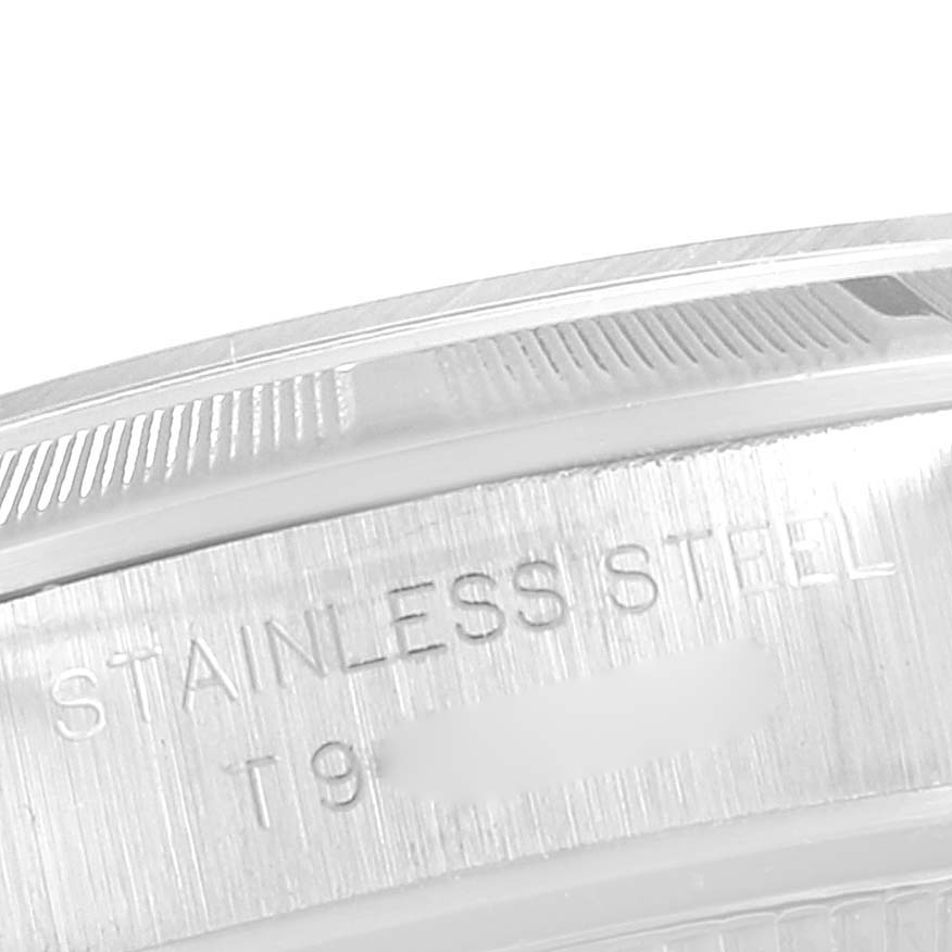 The image shows a close-up of the side of an Oyster Perpetual Rolex watch, focusing on the "Stainless Steel" engraving.