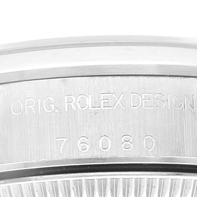 This image shows a close-up of the case back inscription on a Rolex Oyster Perpetual 76080 Women's Stainless Steel Black Dial 76080 Women's Stainless Steel Black Dial watch.