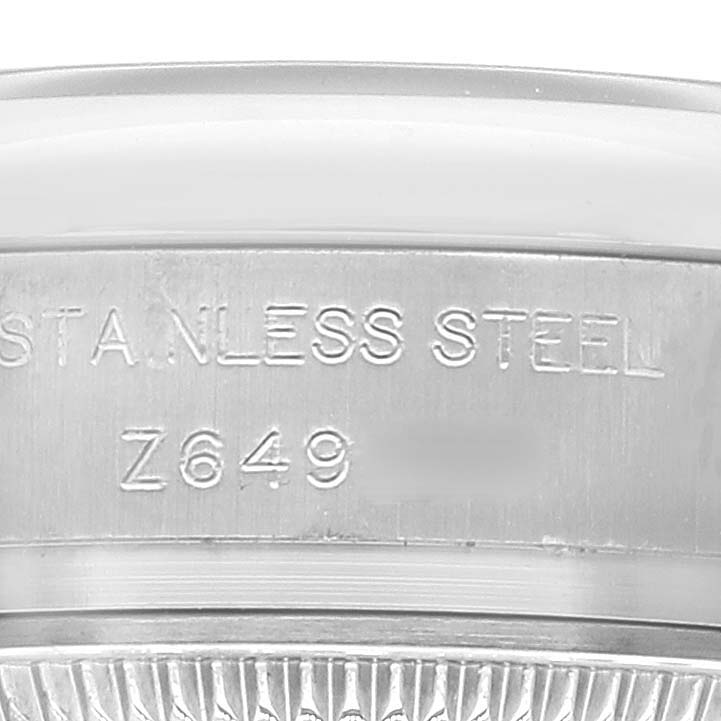 The image shows a close-up of the side engraving on the stainless steel case of a Rolex Oyster Perpetual 176200 Women's Stainless Steel Blue Dial 176200 Women's Stainless Steel Blue Dial watch.