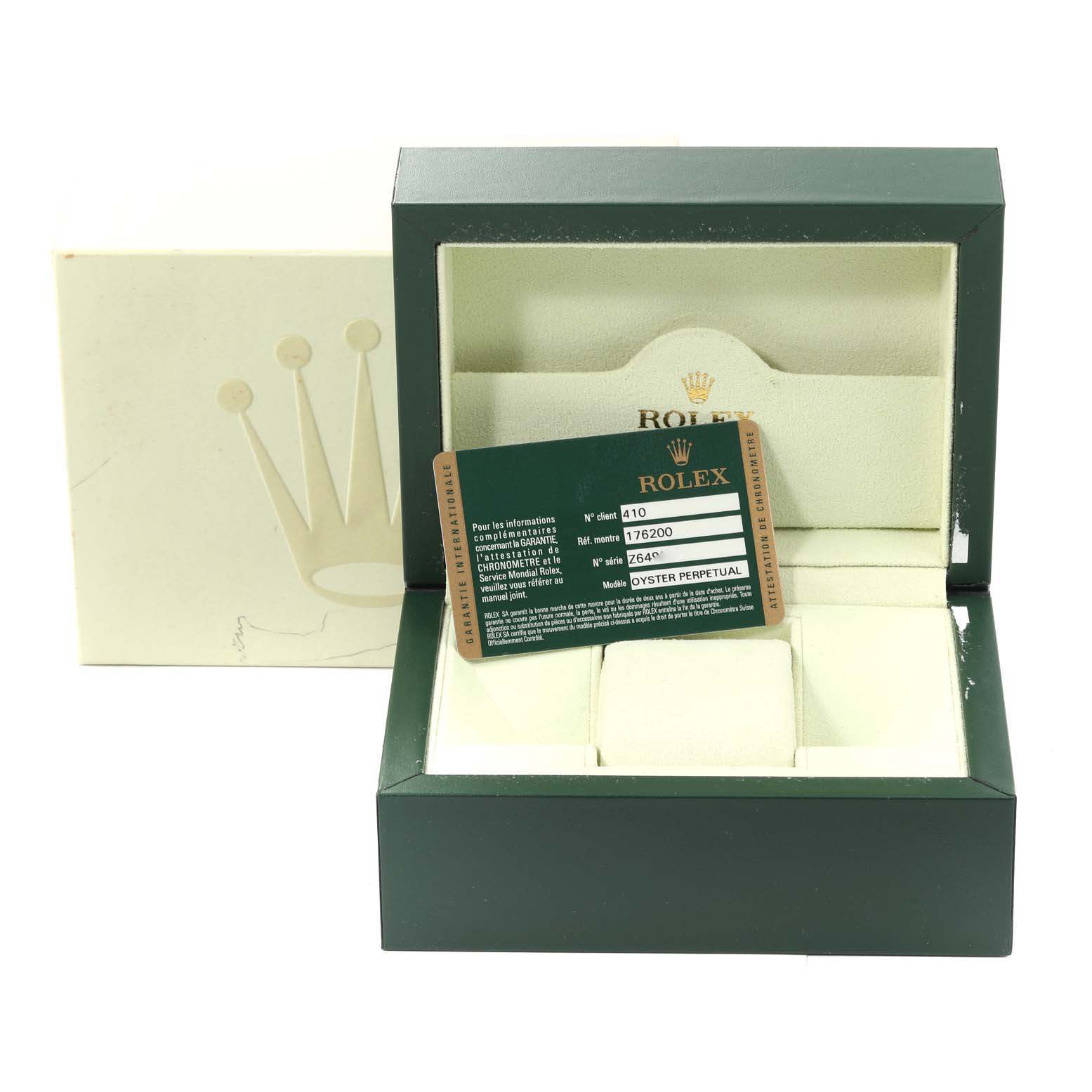 This image shows the packaging, a card, and cushion for a Rolex Oyster Perpetual 176200 Women's Stainless Steel Blue Dial 176200 Women's Stainless Steel Blue Dial watch, viewed from the front.