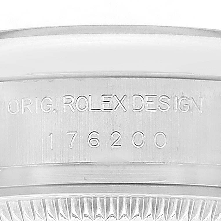 This image shows the side view of the case back of an Oyster Perpetual Rolex watch with engraved text.