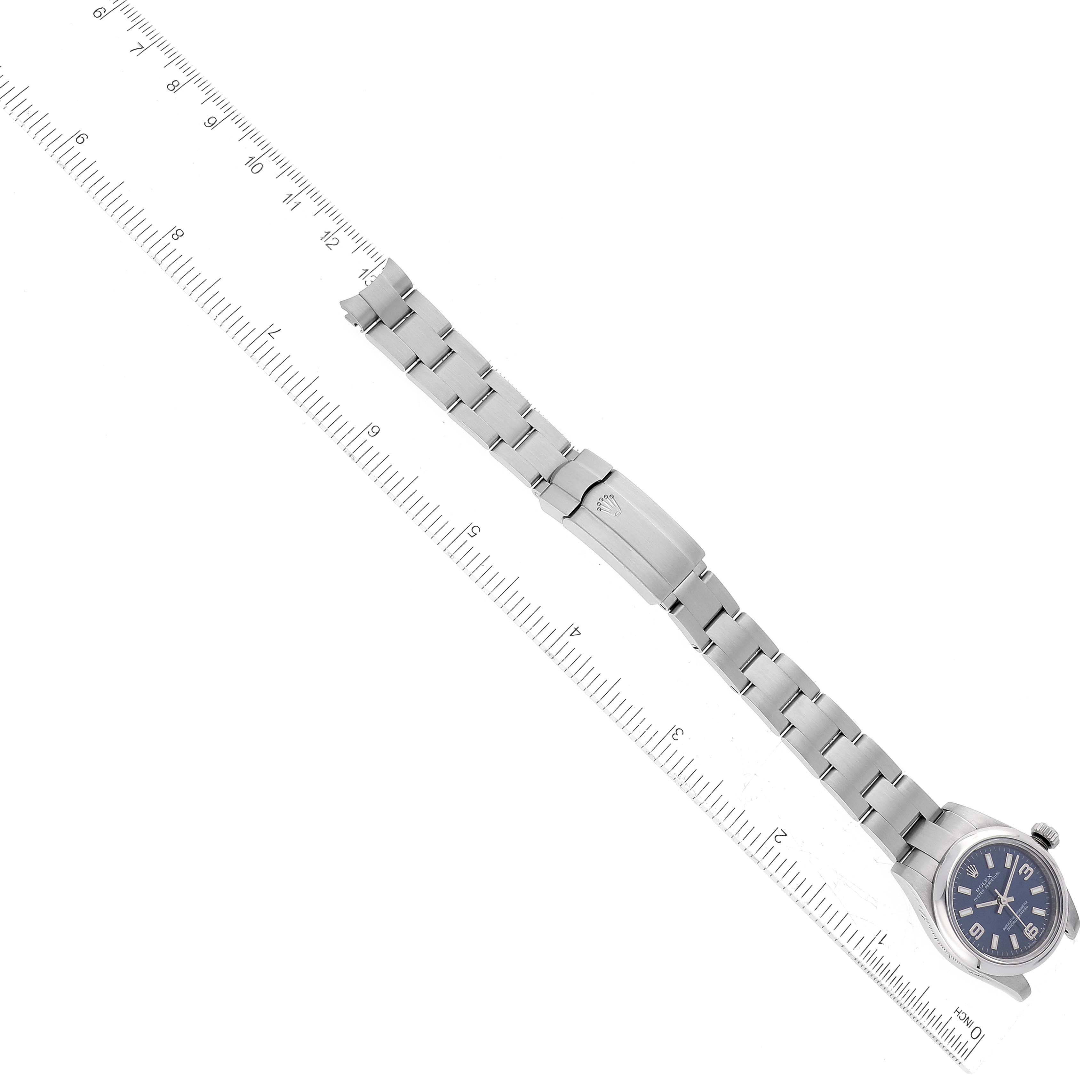 The image shows the Rolex Oyster Perpetual 176200 Women's Stainless Steel Blue Dial 176200 Women's Stainless Steel Blue Dial watch laid flat with its steel bracelet extended and a ruler for scale.