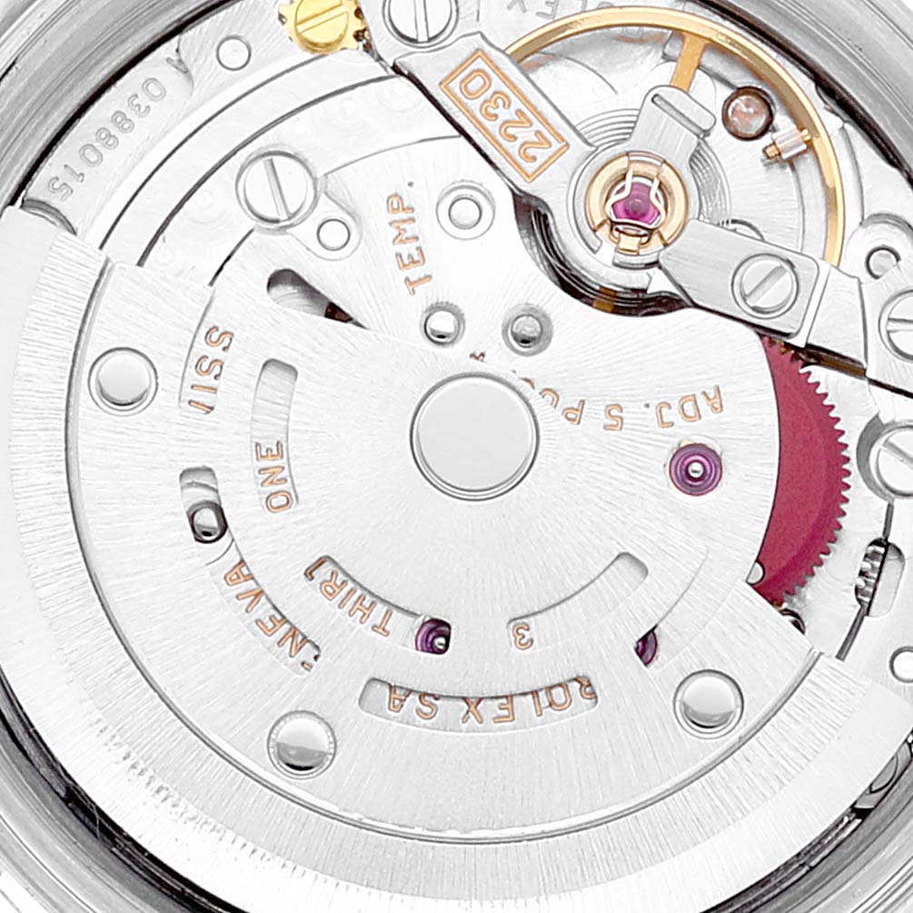 This is a close-up of the movement inside a Rolex Oyster Perpetual 76030 Women
s Stainless Steel Silver Dial 76030 Women
s Stainless Steel Silver Dial watch, showing detailed mechanical parts and engravings.