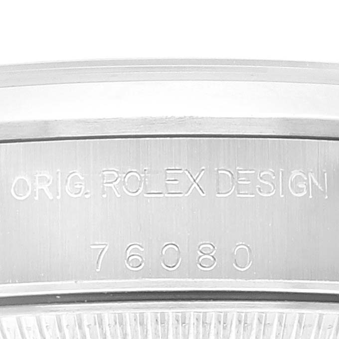 This close-up image shows the engraved case back of a Rolex Oyster Perpetual 76080 Women
s Stainless Steel Silver Dial 76080 Women
s Stainless Steel Silver Dial watch, featuring text "Orig. Rolex Design 76080."