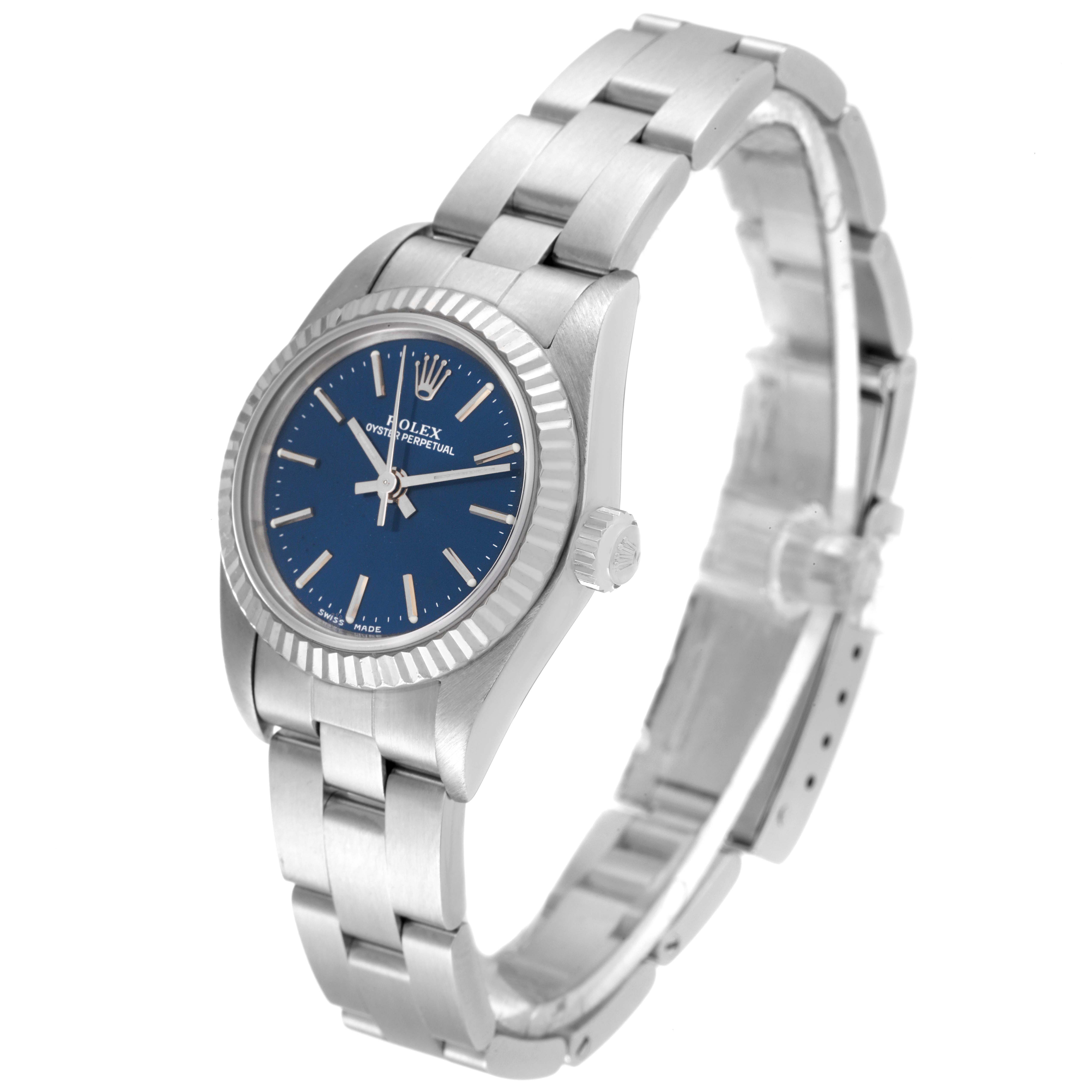 The Rolex Oyster Perpetual 76094 Women
s Stainless Steel Blue Dial 76094 Women
s Stainless Steel Blue Dial watch is shown at a three-quarter angle, highlighting its blue dial, crown, and bracelet.