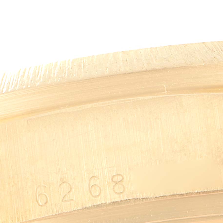 The image shows a close-up of a portion of the bezel of a Rolex President 18078 Men
s Yellow Gold Champagne Dial 18078 Men
s Yellow Gold Champagne Dial model watch, revealing engraved numbers "6268".