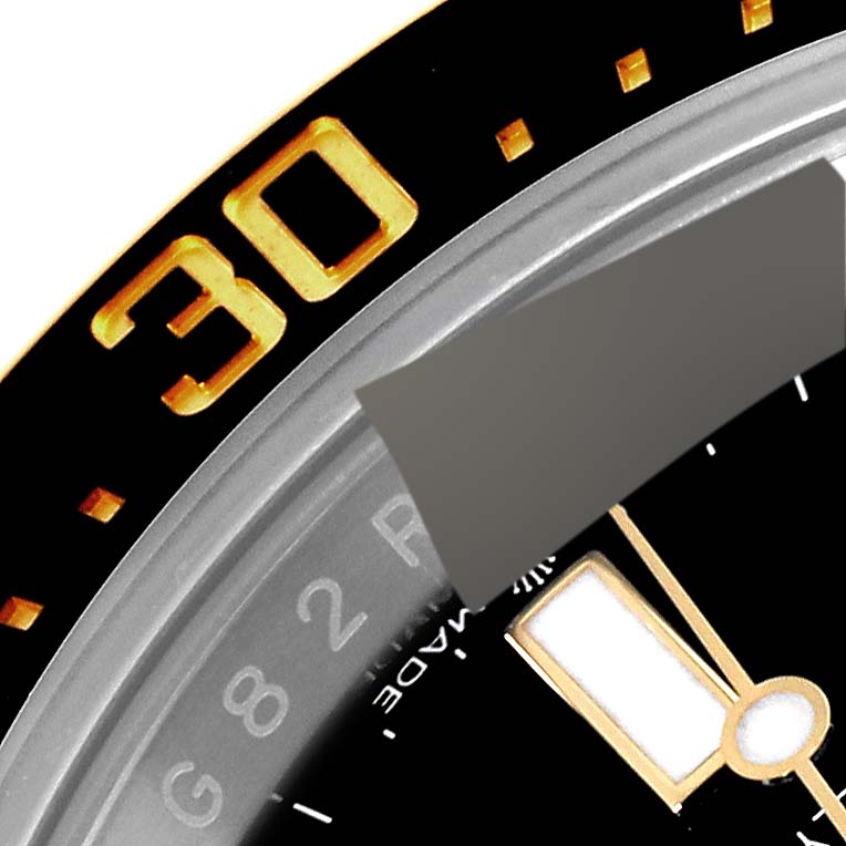 The image shows a close-up of the bezel and part of the dial of a Rolex Sea-Dweller 126603 Men
s Steel and Gold (two tone) Black Dial 126603 Men
s Steel and Gold (two tone) Black Dial watch.