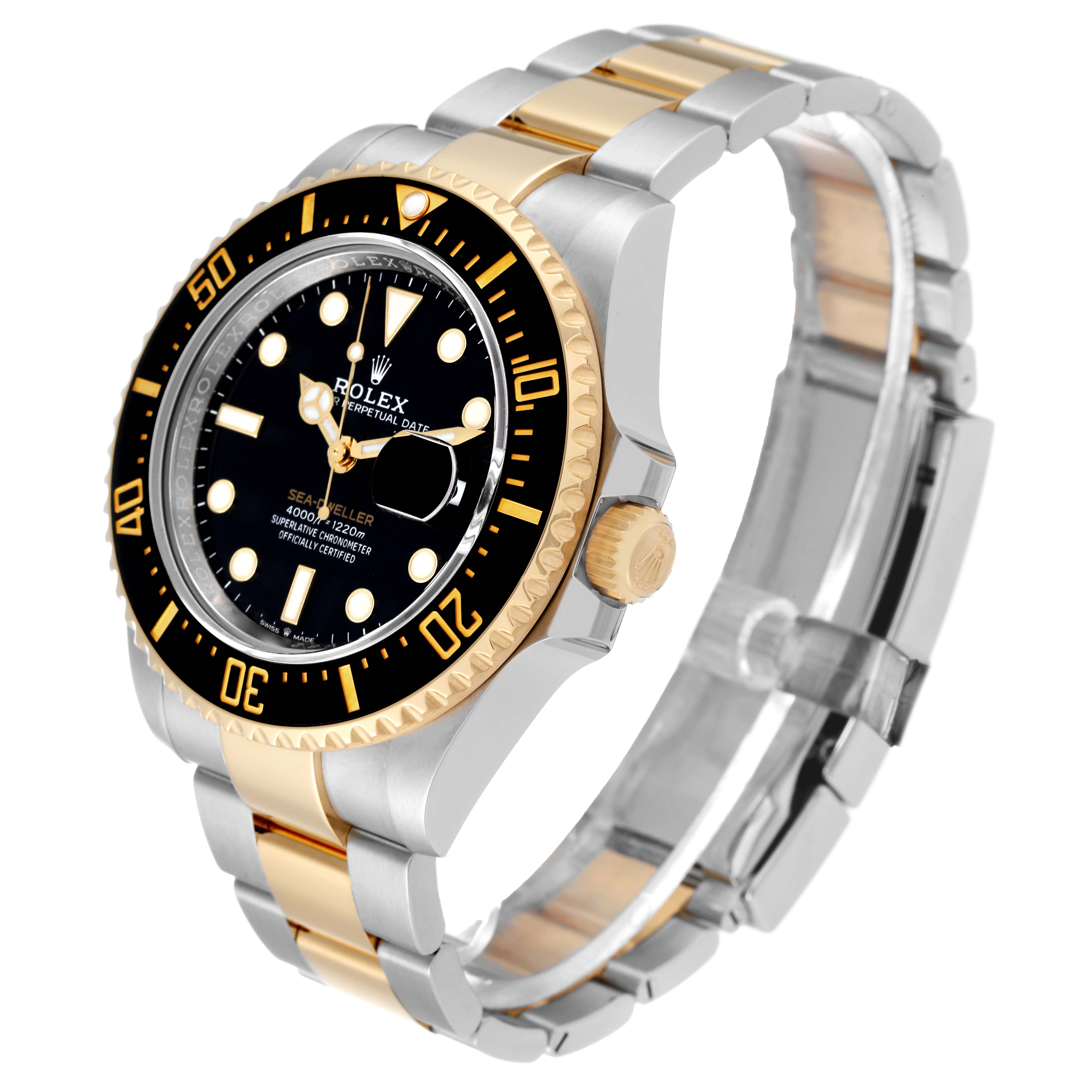 The image shows a Rolex Sea-Dweller 126603 Men
s Steel and Gold (two tone) Black Dial 126603 Men
s Steel and Gold (two tone) Black Dial watch at a 3/4 angle, highlighting its black dial, gold bezel, and two-tone bracelet.