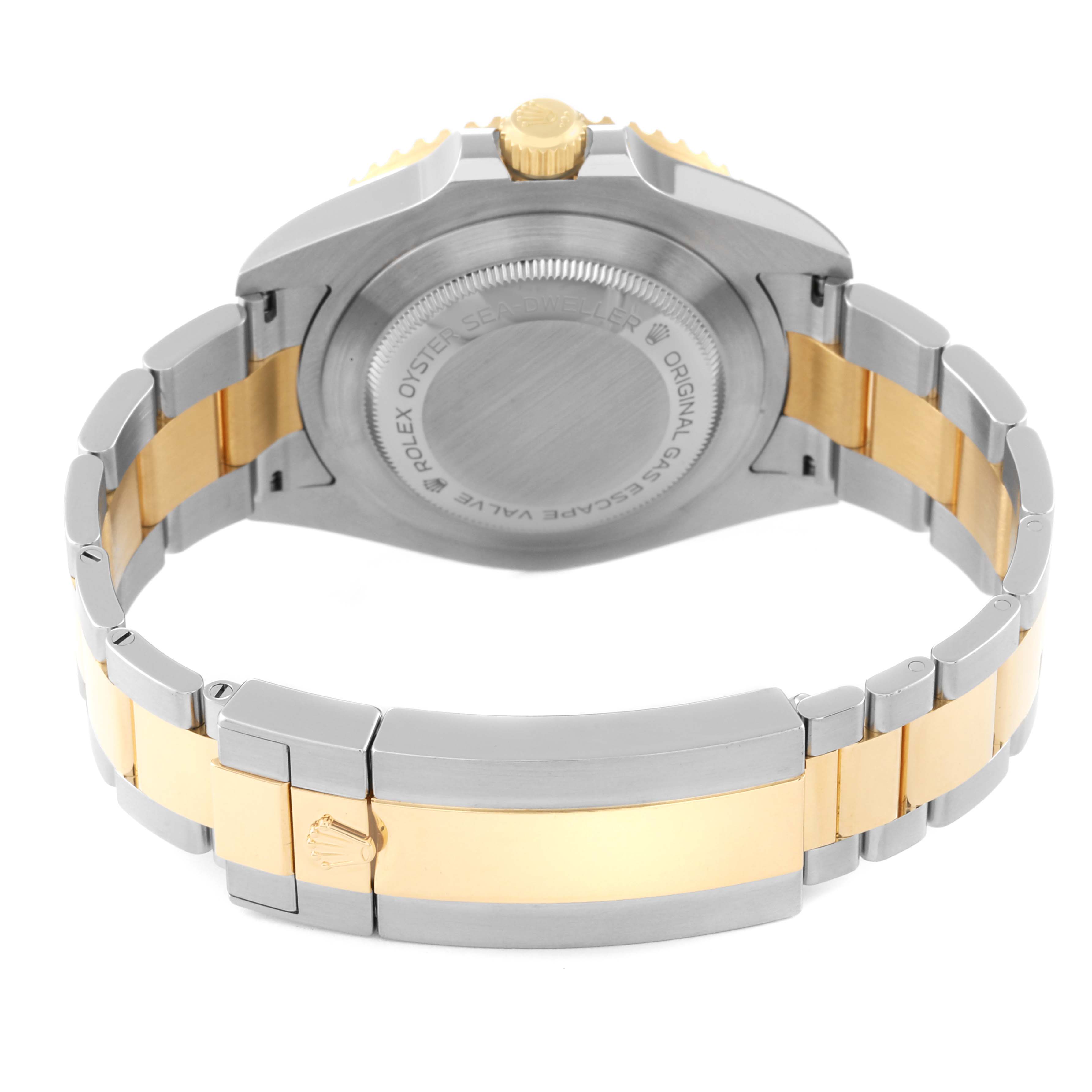 The image shows the back view of a Rolex Sea-Dweller 126603 Men
s Steel and Gold (two tone) Black Dial 126603 Men
s Steel and Gold (two tone) Black Dial watch, highlighting its case back, bracelet, and clasp.