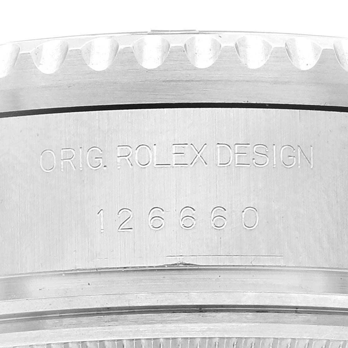 This image shows a close-up of the side of the Rolex Sea-Dweller 126660 Men's Stainless Steel Black Dial 126660 Men's Stainless Steel Black Dial watch case with engraved text "O.RIG. ROLEX DESIGN" and the model number 126660.