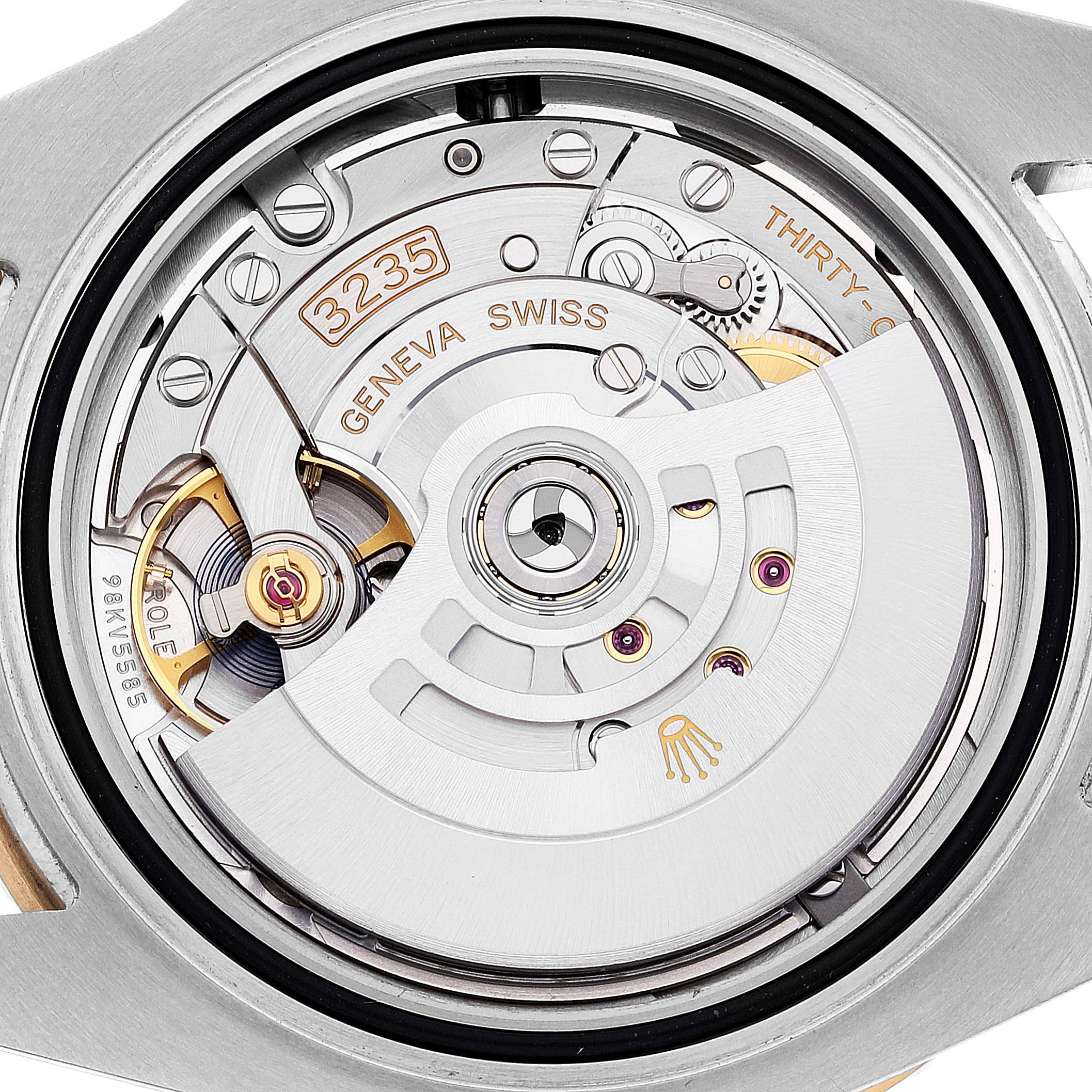 The image shows the movement mechanism of a Rolex Submariner 126613 Men's Steel and Gold (two tone) Blue Dial 126613 Men's Steel and Gold (two tone) Blue Dial, focusing on its intricate gears and components.