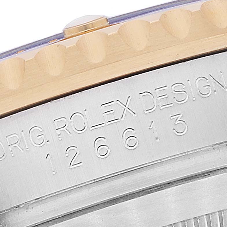 This is a close-up view of the case side of a Rolex Submariner 126613 Men's Steel and Gold (two tone) Blue Dial 126613 Men's Steel and Gold (two tone) Blue Dial, showing the model number and part of the bezel.