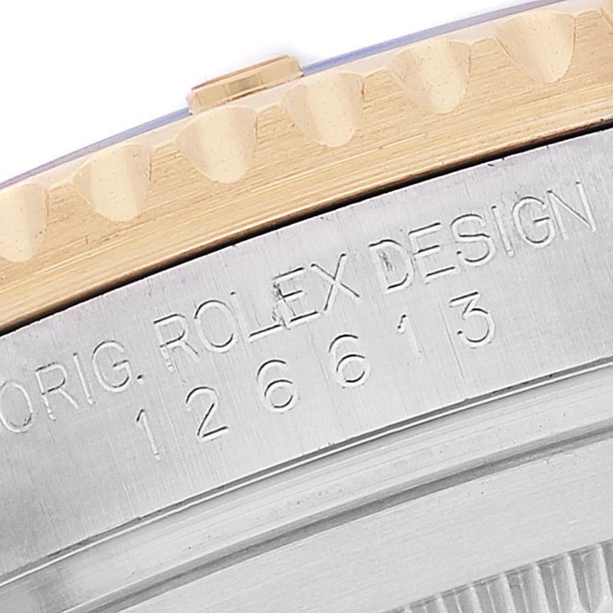 This image shows a close-up side view of a Rolex Submariner 126613 Men's Steel and Gold (two tone) Blue Dial 126613 Men's Steel and Gold (two tone) Blue Dial watch, focusing on the bezel and engraved model number.