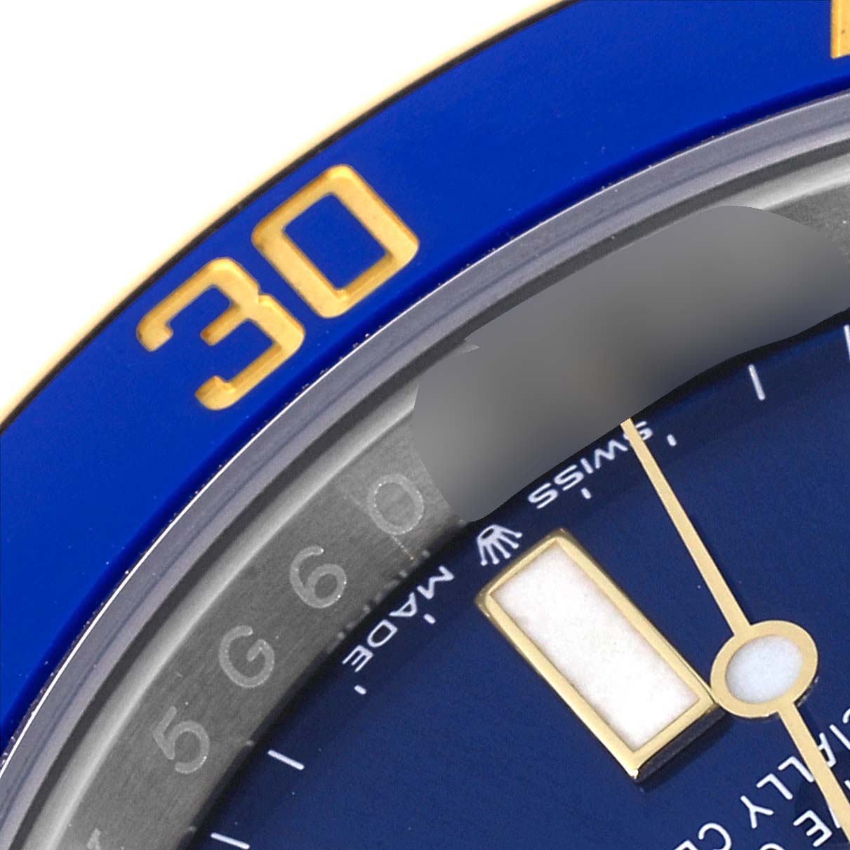 This close-up image shows part of the blue and gold bezel and dial of a Rolex Submariner 126613 Men's Steel and Gold (two tone) Blue Dial 126613 Men's Steel and Gold (two tone) Blue Dial watch.