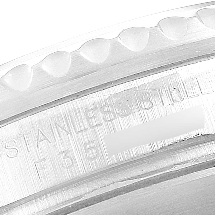 This image shows a close-up of the bezel and part of the case of a Rolex Submariner 16610 Men
s Stainless Steel Black Dial 16610 Men
s Stainless Steel Black Dial watch, highlighting the engraved text.