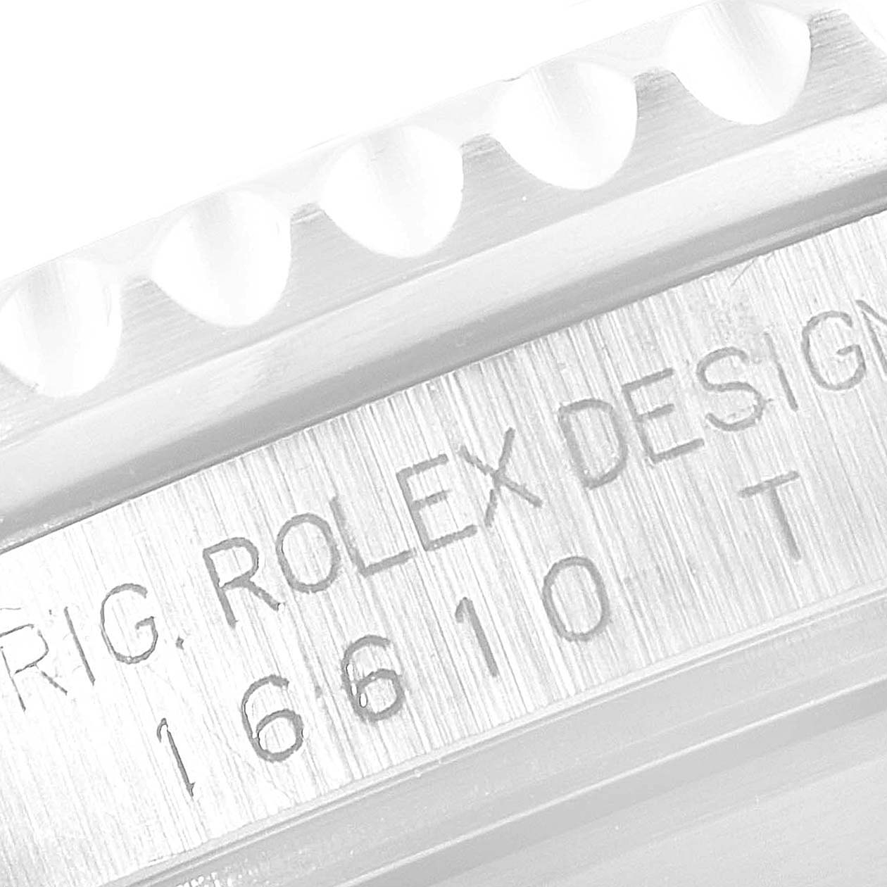 This image shows a close-up of a Rolex Submariner 16610 Men
s Stainless Steel Black Dial 16610 Men
s Stainless Steel Black Dial
s model and serial number engravings on the side of the watch case.