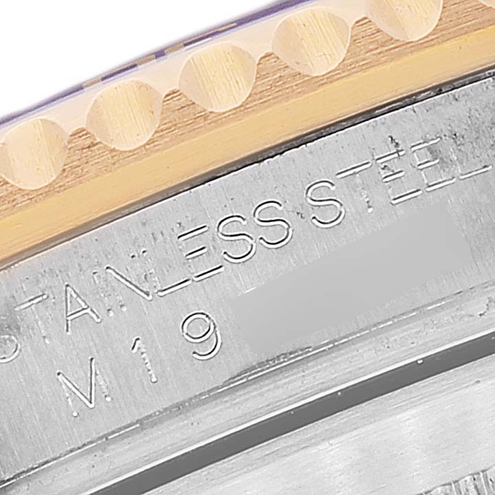 The image shows a close-up of the bezel and the engraved text on the case of a Rolex Submariner 16613 Men's Steel and Gold (two tone) Blue Dial 16613 Men's Steel and Gold (two tone) Blue Dial watch.