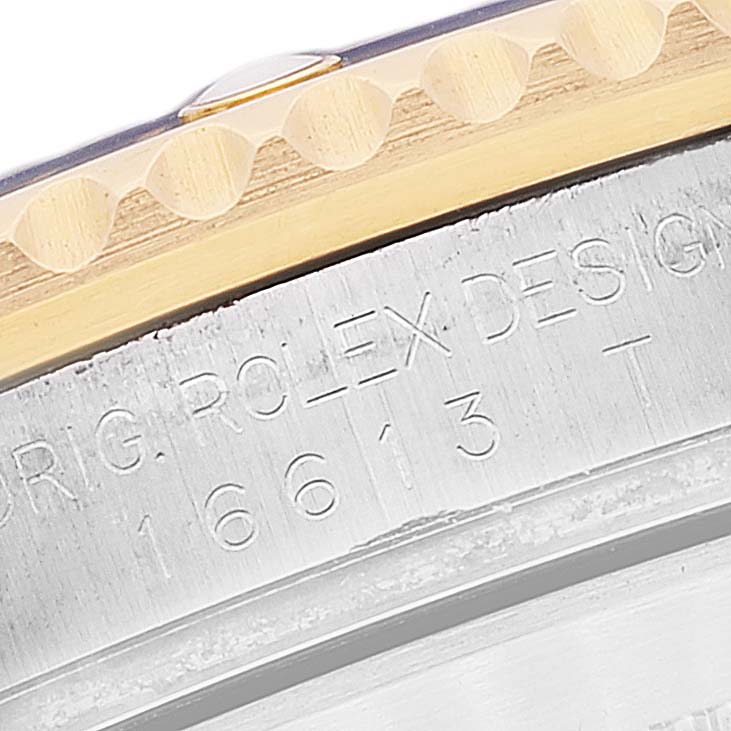 A close-up angle showing the engraved case and part of the bezel of a Rolex Submariner 16613 Men's Steel and Gold (two tone) Blue Dial 16613 Men's Steel and Gold (two tone) Blue Dial.