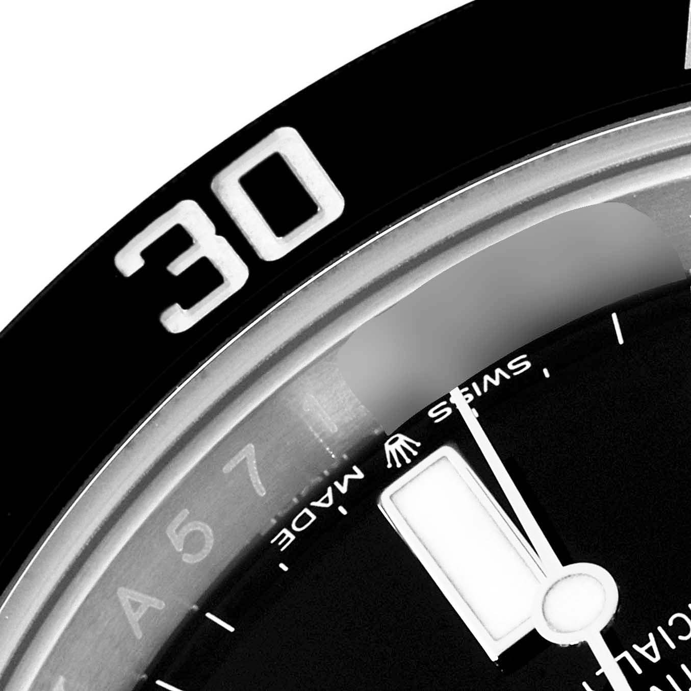 This close-up angle of the Rolex Submariner 124060 Men's Stainless Steel Black Dial 124060 Men's Stainless Steel Black Dial watch shows part of the bezel with the numeral "30" and a portion of the dial.