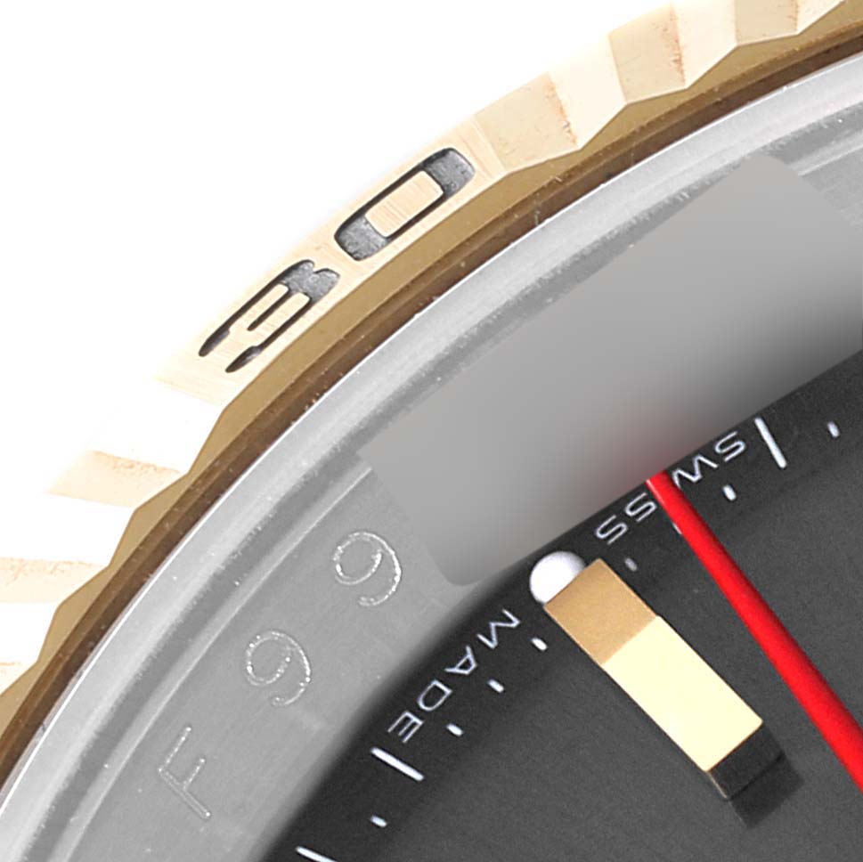 The image showcases a close-up of the bezel and part of the dial of a Rolex Turn-o-Graph 116263 Men
s Steel and Gold (two tone) Grey Dial 116263 Men
s Steel and Gold (two tone) Grey Dial watch, highlighting the 30-minute mark.