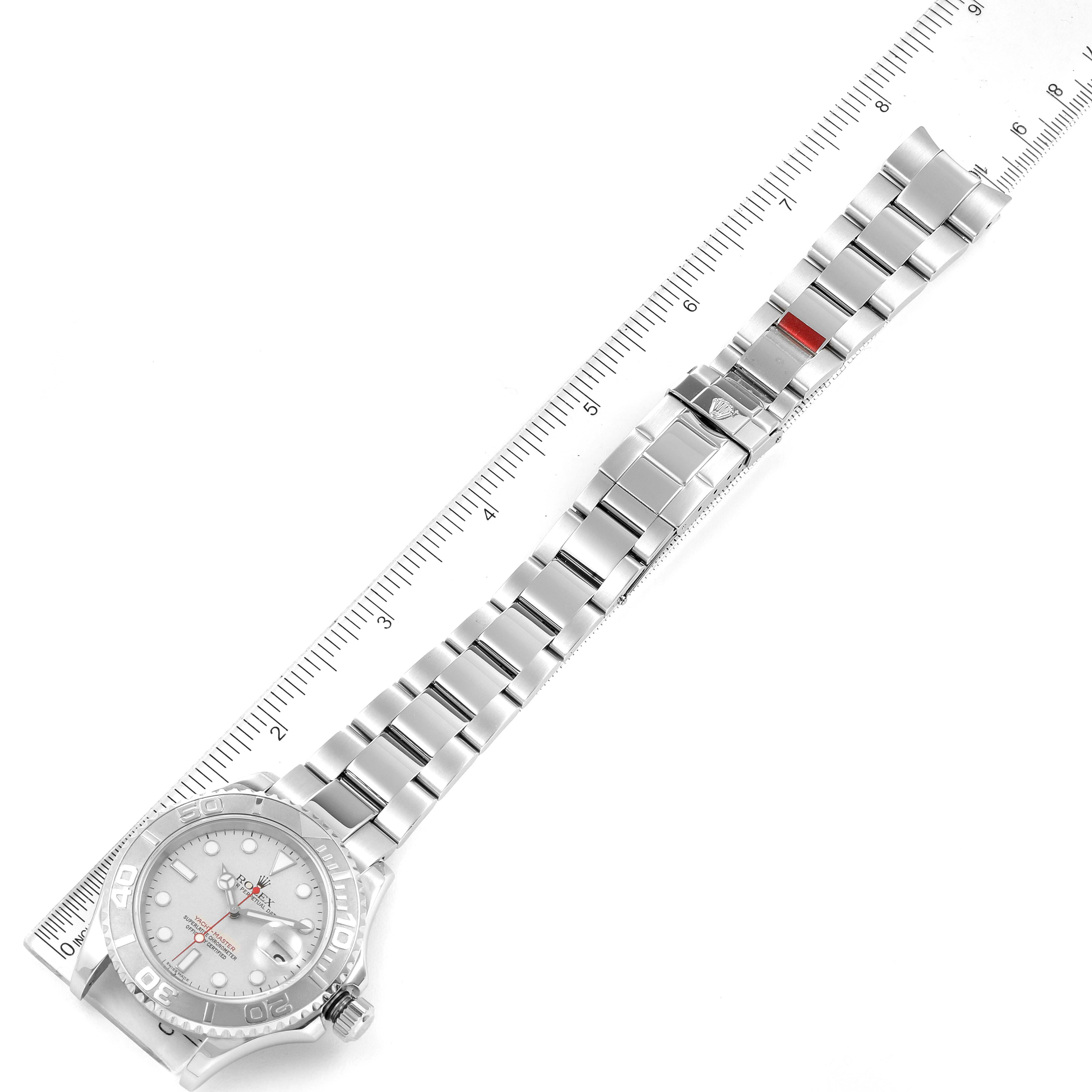 The image shows a top-down view of a Rolex Yacht-Master 16622 Men's Stainless Steel Silver Dial 16622 Men's Stainless Steel Silver Dial watch with its full metal bracelet and a ruler for scale.