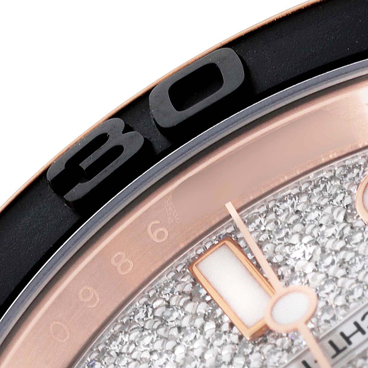 The image shows a close-up of the Rolex Yacht-Master 116655 Men's Rose Gold Pink Dial 116655 Men's Rose Gold Pink Dial watch's bezel, dial, and part of the hour hand.
