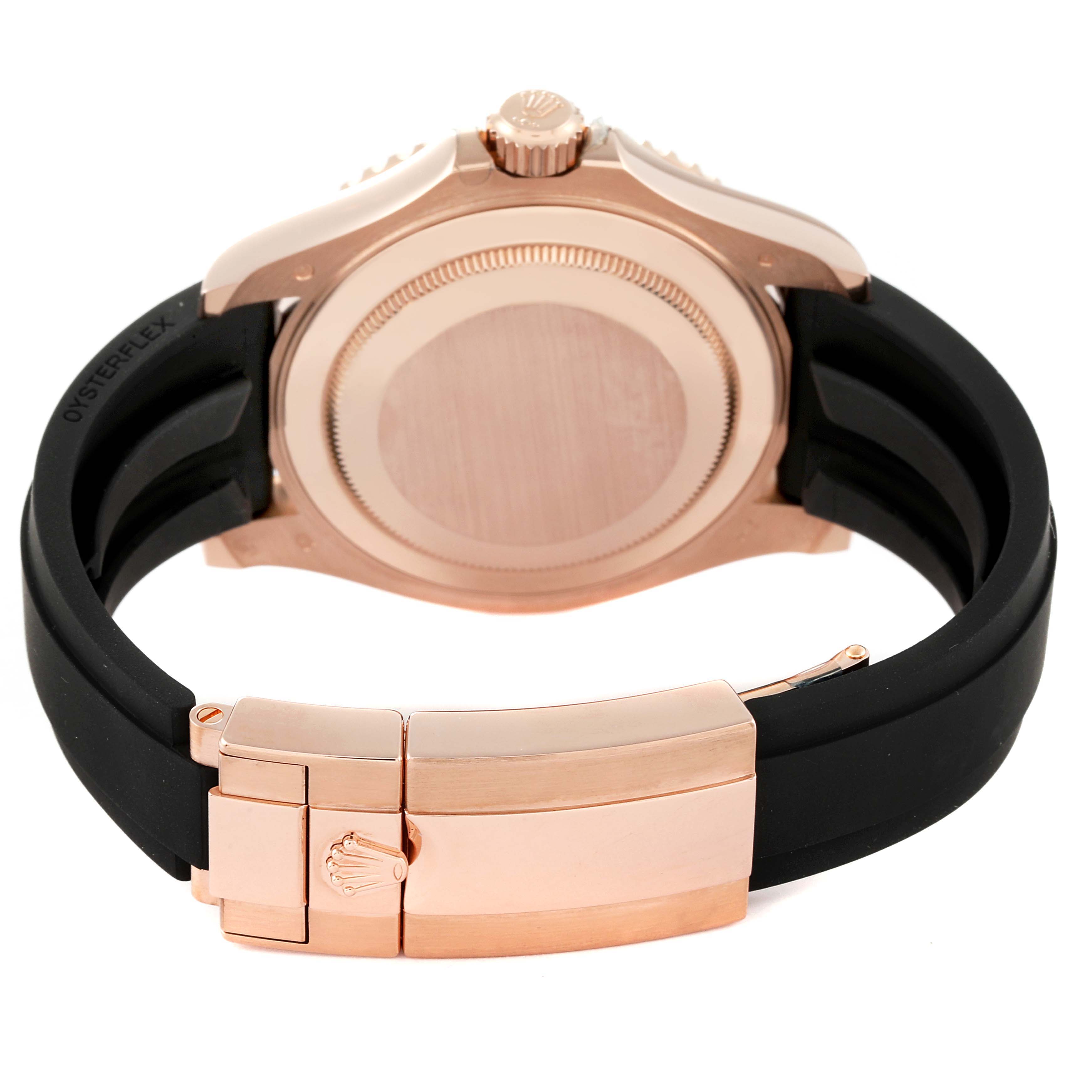 The image shows the back case, crown, and clasp of a Rolex Yacht-Master 116655 Men's Rose Gold Pink Dial 116655 Men's Rose Gold Pink Dial watch with a rose gold finish and black Oysterflex strap.