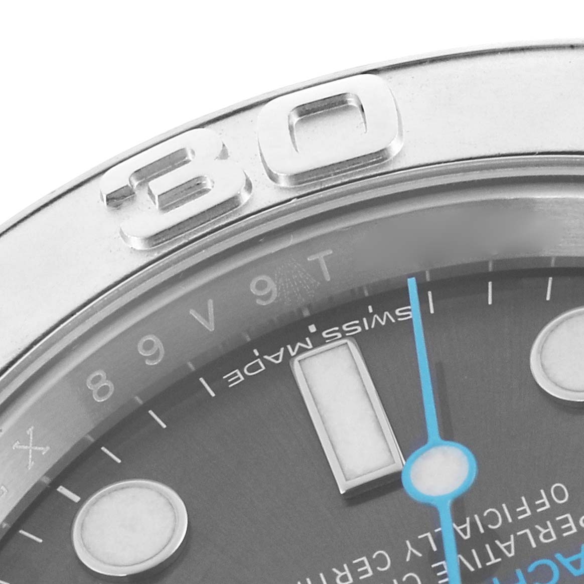 The image shows a close-up of the Rolex Yacht-Master 116622 Men's Stainless Steel Grey Dial 116622 Men's Stainless Steel Grey Dial watch's bezel, part of the dial, and the minute hand.