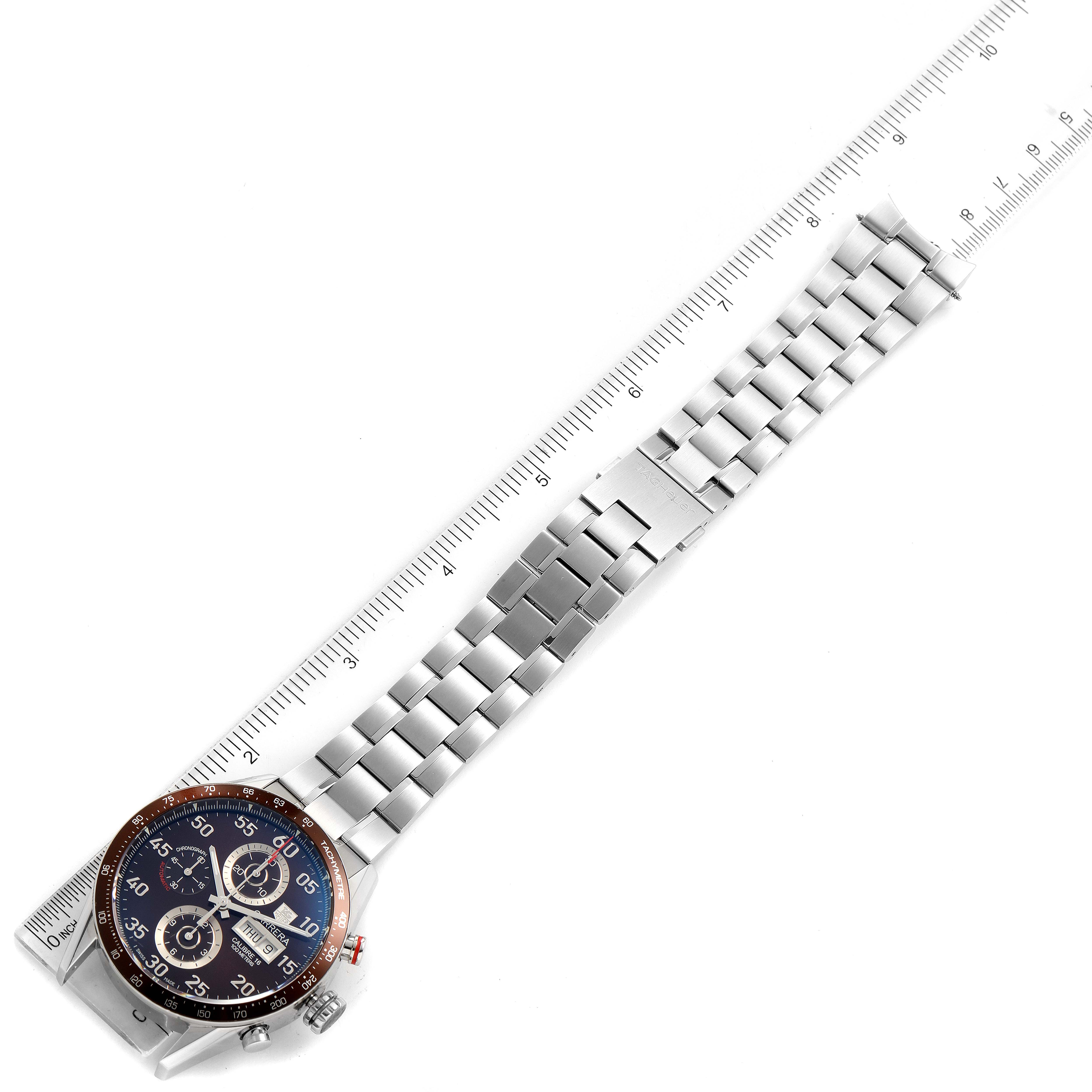 The image shows a Tag Heuer Carrera CV2A12.FC6236 Men's Stainless Steel Brown Dial CV2A12.FC6236 Men's Stainless Steel Brown Dial watch laid flat with a view of the dial and metal bracelet alongside a ruler for scale.