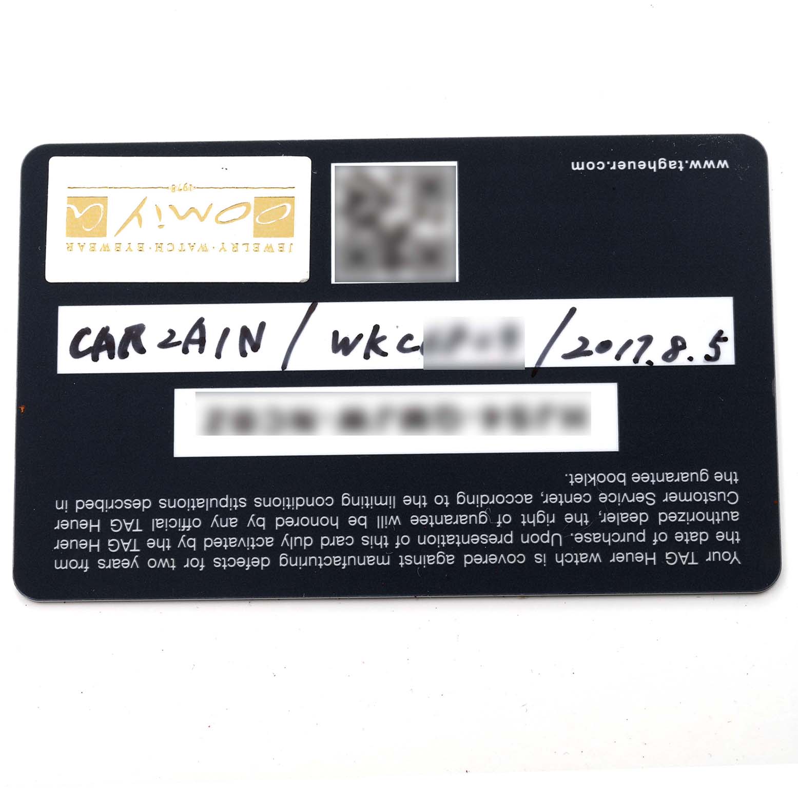 The image shows the warranty card for a Tag Heuer Carrera CAR2A1N.FT6100 Men's Stainless Steel Blue Dial CAR2A1N.FT6100 Men's Stainless Steel Blue Dial model watch, photographed from above.