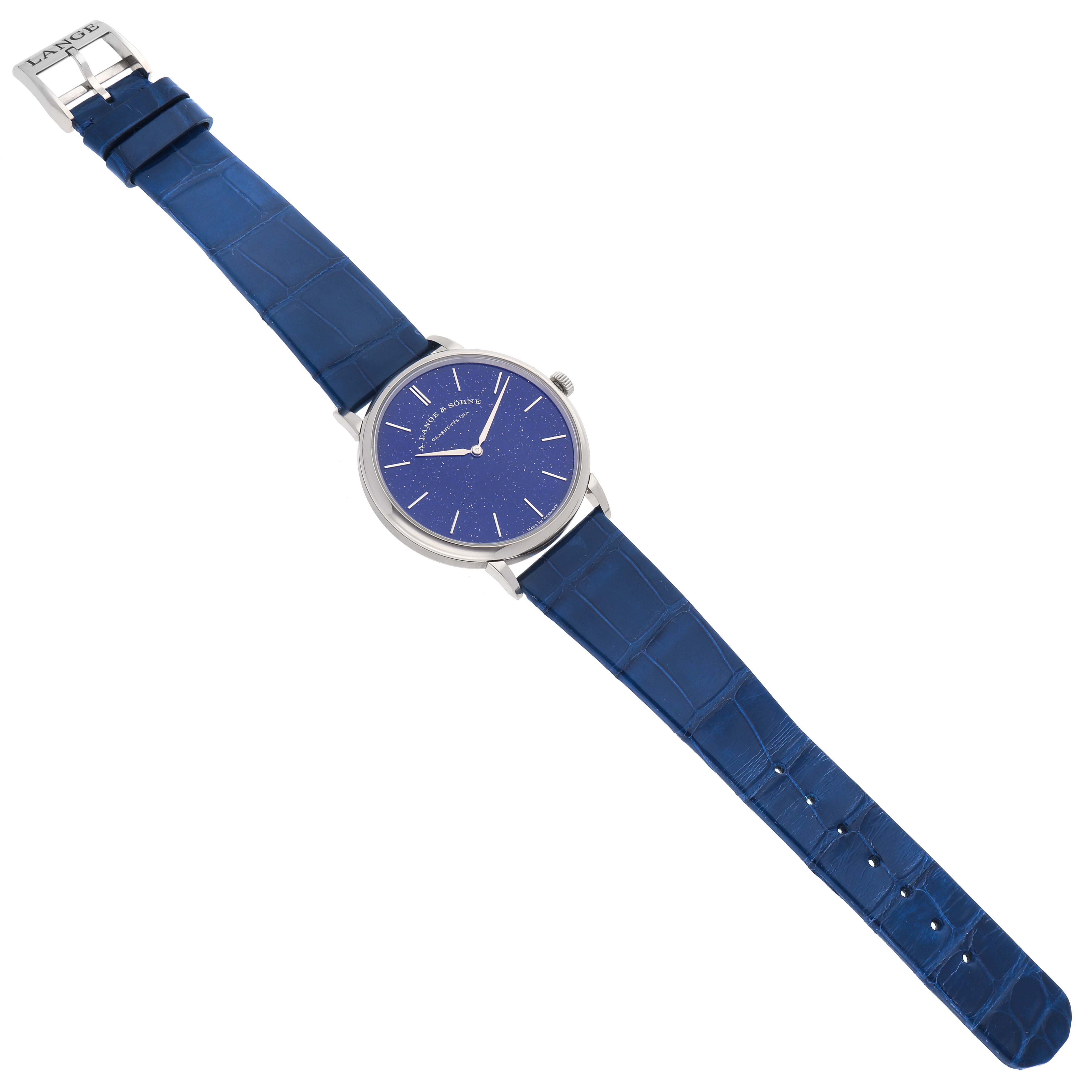 The watch is shown from a top-down angle, displaying the full A. Lange & Sohne Saxonia 205.086 Men's White Gold Blue Dial with a blue strap and dial.