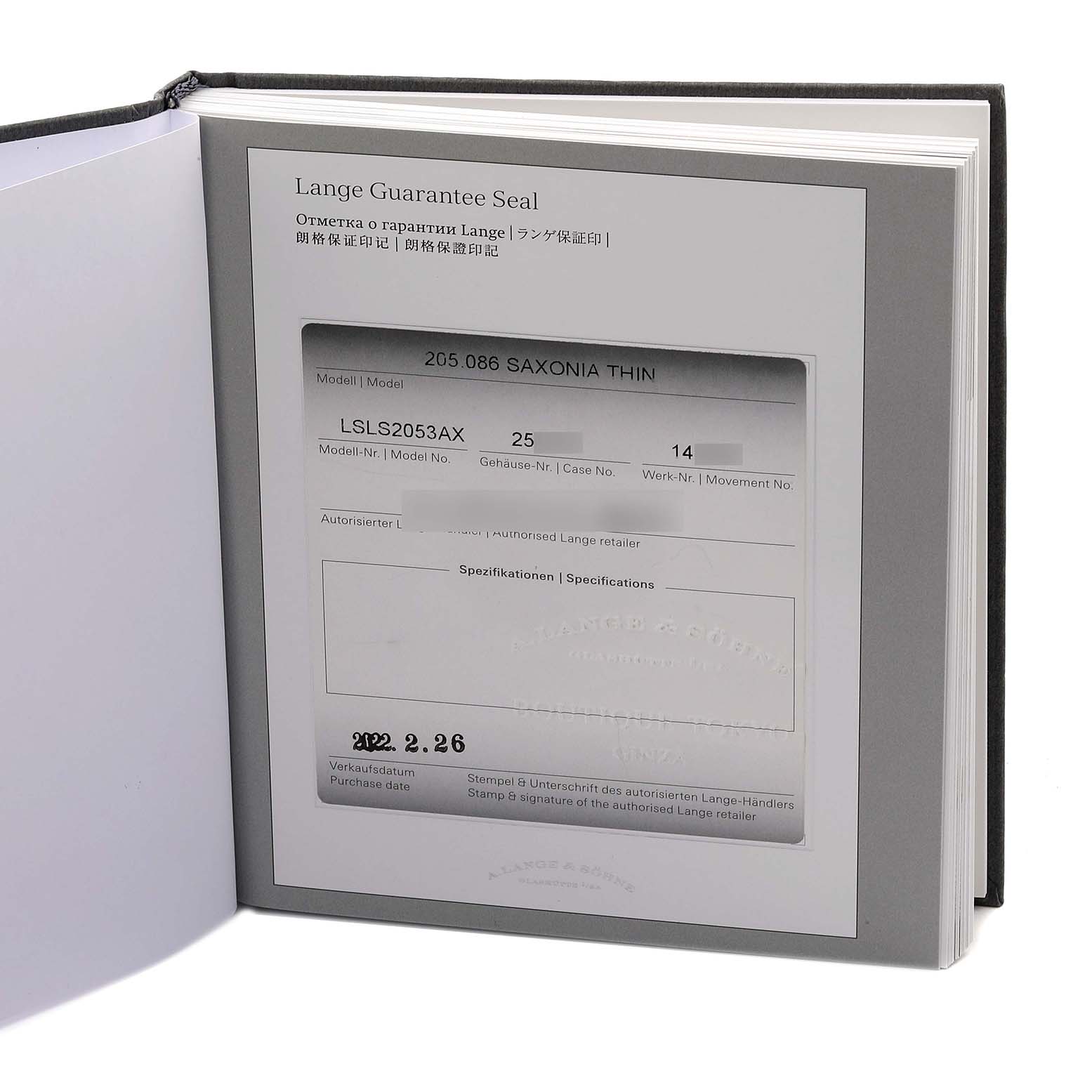 The image shows the guarantee paperwork for the A. Lange & Sohne Saxonia 205.086 Men's White Gold Blue Dial model.
